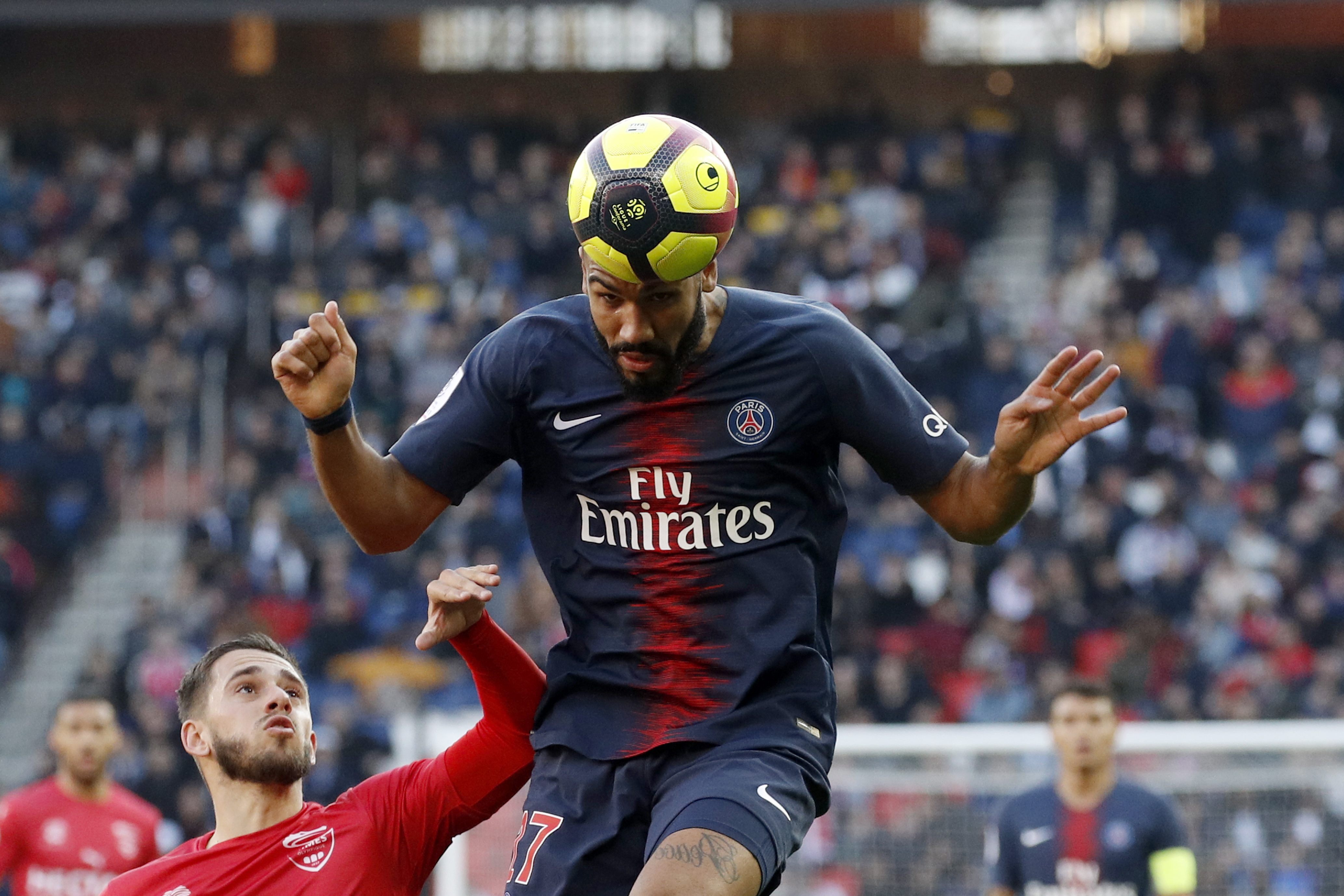 epa07390788 Paris Saint Germain's Eric Maxim Choupo-Moting (C) and Pierrick Valdivia of Nimes (L) in action during the French Ligue 1 soccer match between PSG and Nimes at the Parc des Princes stadium in Paris, France, 23 February 2019.  EPA/YOAN VALAT