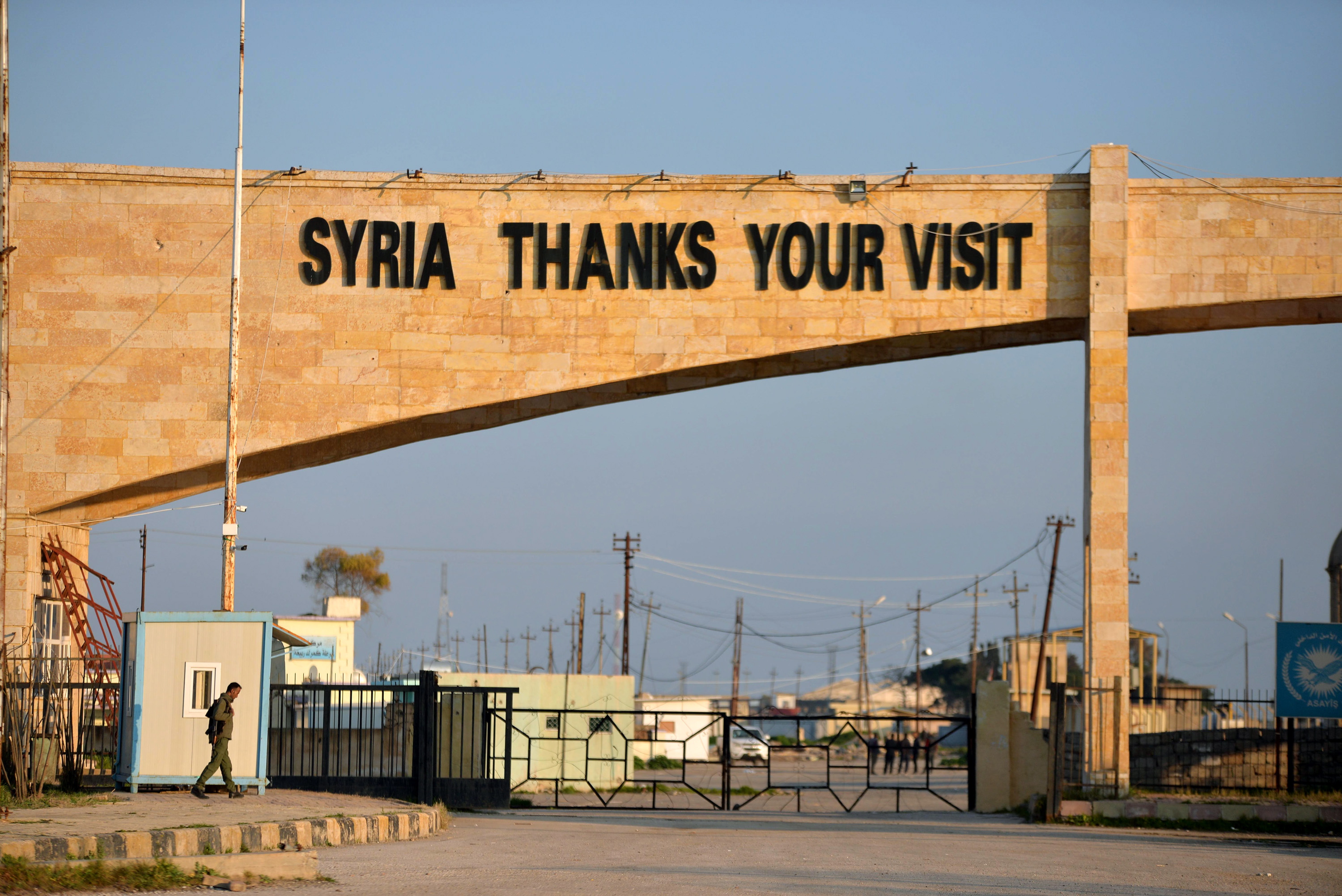 epa07391292 A member of US-backed Syrian Democratic Forces (SDF), stands guard at Ya'arubiya border crossing with Iraq in northeastern Hasakah province, northern Syria on 23 February 2019. Ya'arubiya crossing is the only one of three crossings on the Iraqi borders, which also known as Rabia'a on the Iraqi side. In 2014, the Islamic State (IS) group seized control over the crossing when swept large parts of Syria and Iraq lands, and declaring a so-called 'caliphate' in areas it controlled, before US-backed Iraqi forces drove them out from west of Iraqi in 2016, and defeated them in all of Iraq in late 2017.  EPA/MURTAJA LATEEF