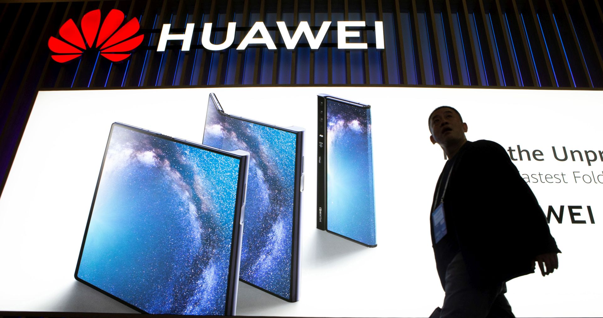 epa07396786 A visitor walks past the stand of Huawei on the opening day of the Mobile World Congress 2019 (MWC19), in Barcelona, Spain, 25 February 2019. The MWC19 will present the latest advances in mobile technologies from 25 to 28 February at the Fira Barcelona Montjuic.  EPA/Enric Fontcuberta