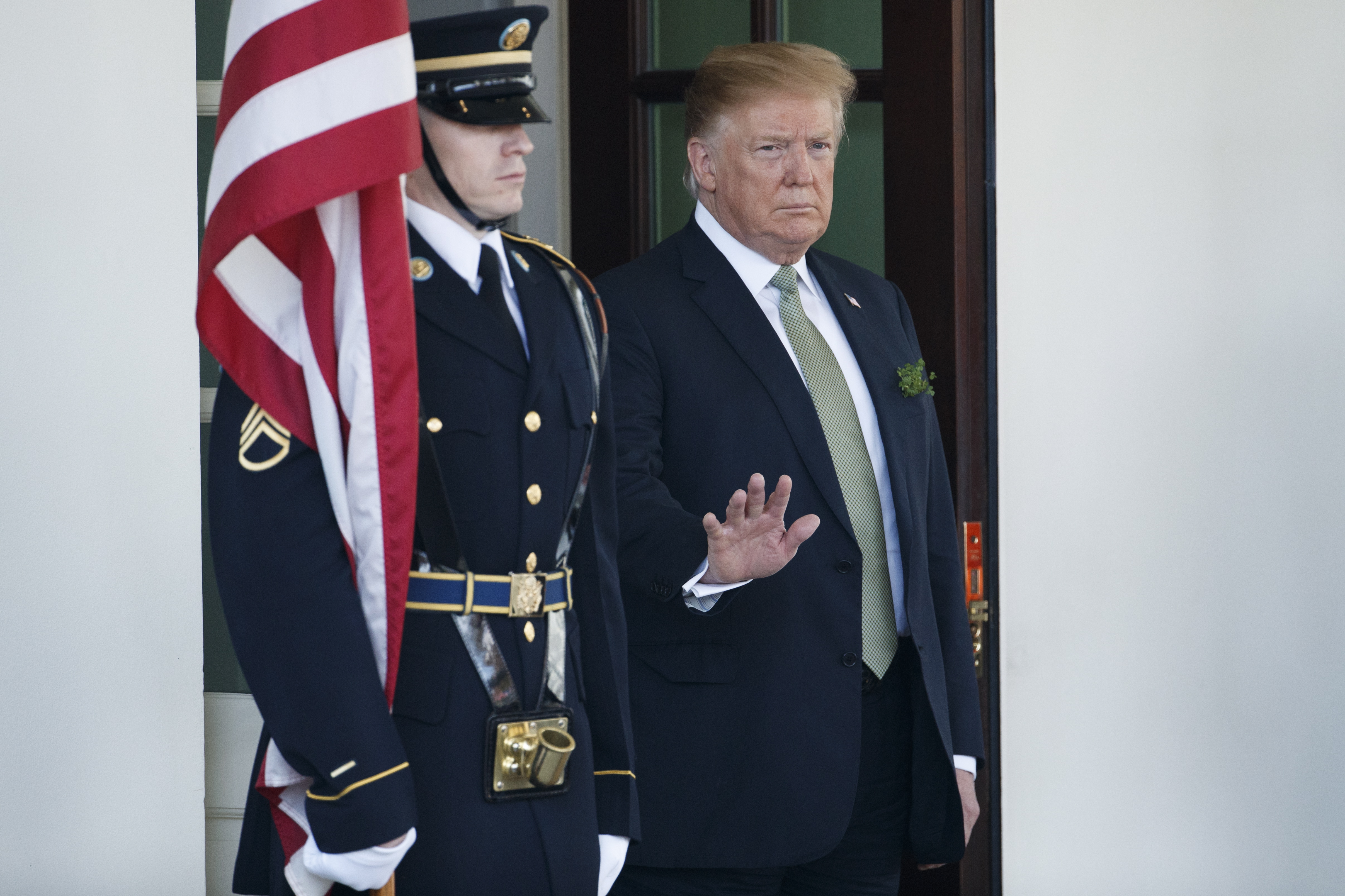 epa07436633 US President Donald J. Trump (L) waits for Irish Taoiseach Leo Varadkar as he arrives at the West Wing of the White House in Washington, DC, USA, 14 March 2019. The President and Taoiseach will meet in the Oval Office, visit the US Capitol and finally participate in the Shamrock Bowl Presentation at a White House reception.  EPA/SHAWN THEW