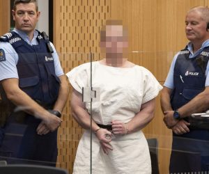 epa07441050 Brenton Tarrant (Pixelated) makes a sign to the camera during his appearance, on a charge of murder for Christchurch mosque massacre in the District Court, Christchurch, New Zealand, 16 March 2019. At least 49 people were killed by a gunman, believed to be Brenton Harrison Tarrant, and 20 more injured and in critical condition during the terrorist attacks against two mosques in New Zealand during Friday prayers on 15 March.  EPA/Martin Hunter / POOL NEW ZEALAND OUT