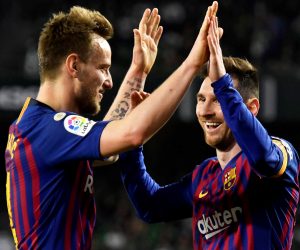 epa07446022 FC Barcelona's Lionel Messi (R) celebrates with his teammate Ivan Rakitic (L) after scoring the 4-1 lead during the Spanish La Liga soccer match between Real Betis and FC Barcelona in Seville, southern Spain, 17 March 2019.  EPA/RAUL CARO