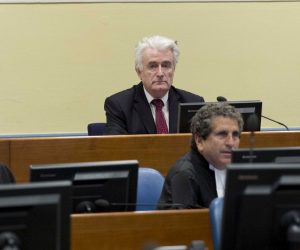 epa07450646 Former Bosnian Serb leader Radovan Karadzic (C, rear) sits in the court room of the International Residual Mechanism for Criminal Tribunals in The Hague, Netherlands, 20 March 2019. Nearly a quarter of a century since Bosnia's devastating war ended, Karadzic is set to hear the final judgment on whether he can be held criminally responsible for unleashing a wave of murder and destruction. United Nations appeals judges will on Wednesday rule whether to uphold or overturn Karadzic's 2016 convictions for genocide, crimes against humanity and war crimes, as well as his 40-year sentence.  EPA/PPETER DEJONG
