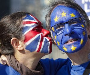 epa07452916 Two protesters with their faces painted with the colors of EU and British flags during a protest staged by about 20 anti-Brexit demonstrators calling for a second referendum on Brexit in front of EU Commission Building ahead of EU Summit in Brussels, Belgium, 21 March 2019. European Union leaders will gather for a two-day summit to discuss, among others, Brexit and British PM request to extend Article 50.  EPA/OLIVIER HOSLET