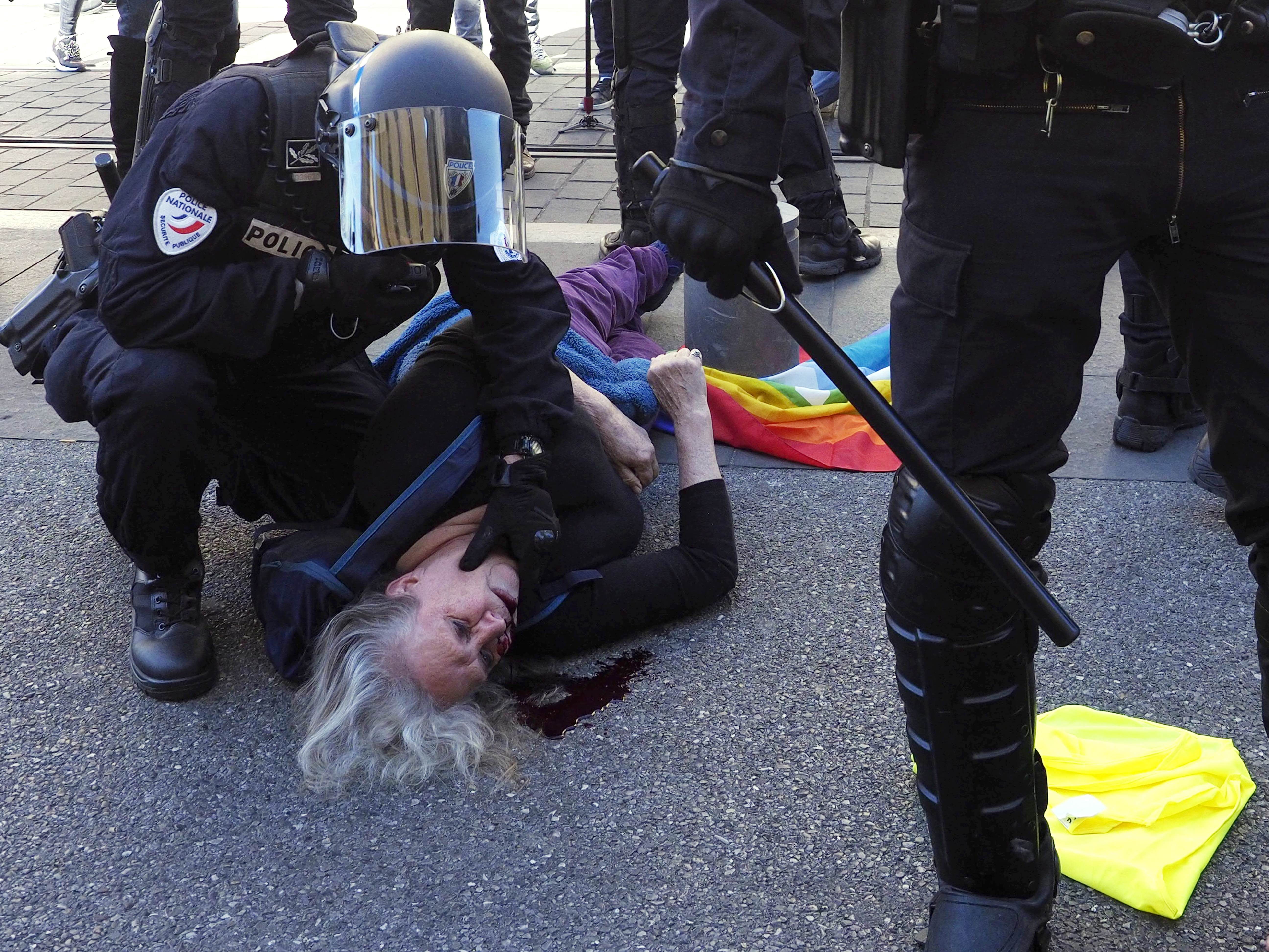 epa07457816 A bleeding woman lies on the floor after being injured during an assault by French Police forces during the 'Act XIX' demonstration (the 19th consecutive national protest on a Saturday) in Nice, France, 23 March 2019. To prevent a repeat of the last week riots on the Champs-Elysees, French authorities have banned demonstrations in large zones of different cities.  EPA/ARNOLD JEROCKI