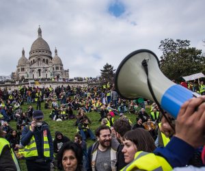 epa07458915 Protesters from the 'Gilets Jaunes' (Yellow Vests) gather in front of the Sacre-Coeur Basilica of Montmartre during the 'Act XIX' demonstration (the 19th consecutive national protest on a Saturday) in Paris, France, 23 March 2019. To prevent a repeat of the last week riots, French authorities have banned demonstrations in a large area in the west of Paris, including the Champs-Elysees. Yellow vest organizers called on social media for protests in different places in Paris, including the Trocadero square.  EPA/CHRISTOPHE PETIT TESSON