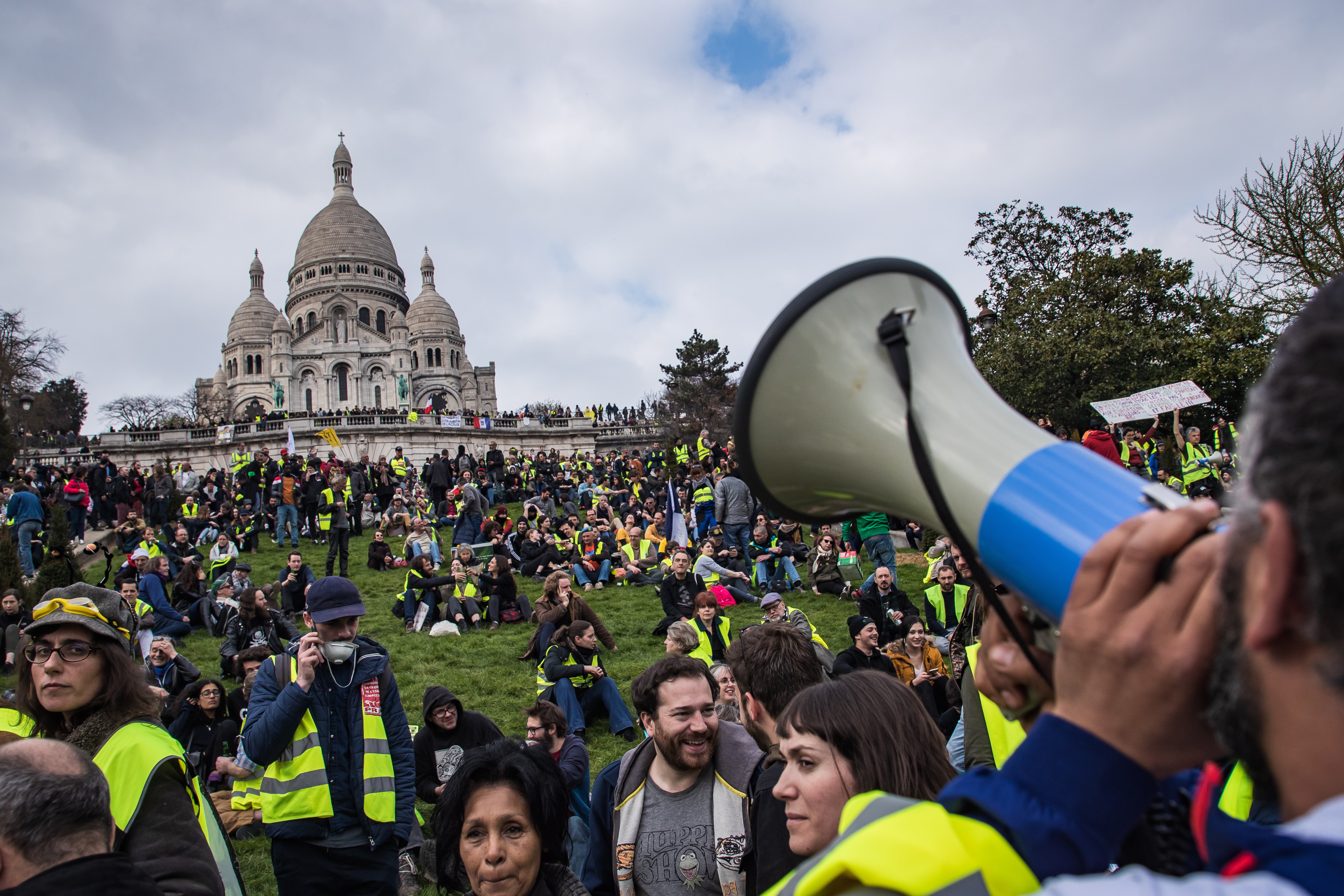 epa07458915 Protesters from the 'Gilets Jaunes' (Yellow Vests) gather in front of the Sacre-Coeur Basilica of Montmartre during the 'Act XIX' demonstration (the 19th consecutive national protest on a Saturday) in Paris, France, 23 March 2019. To prevent a repeat of the last week riots, French authorities have banned demonstrations in a large area in the west of Paris, including the Champs-Elysees. Yellow vest organizers called on social media for protests in different places in Paris, including the Trocadero square.  EPA/CHRISTOPHE PETIT TESSON