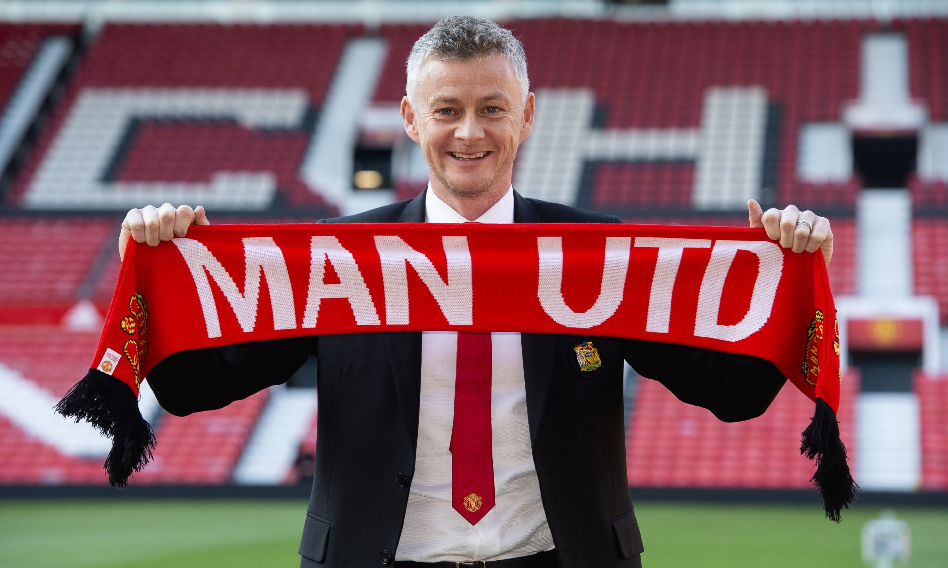epa07469147 Ole Gunnar Solskjaer holds a scarf pitch side inside Old Trafford after being announced as the new manager of Manchester United  at Old Trafford, Manchester, Britain, 28 March 2019.  EPA/PETER POWELL EDITORIAL USE ONLY. No use with unauthorized audio, video, data, fixture lists, club/league logos or 'live' services. Online in-match use limited to 120 images, no video emulation. No use in betting, games or single club/league/player publications
