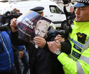 epa07499785 A protester scuffles with police outside of the Westminister Magistrates Court, London, Britain, 11 April 2019, where Wikileaks founder Julian Assange was due to appear after he was arrest at the Ecuadorian Embassy in south west London, earlier in the day. Wikileaks founder Julian Assange was arrested at the Ecuadorian Embassy in London, where he has claimed political asylum since June 2012, after he was accused of rape and sexual assault against women in Sweden.  EPA/FACUNDO ARRIZABALAGA