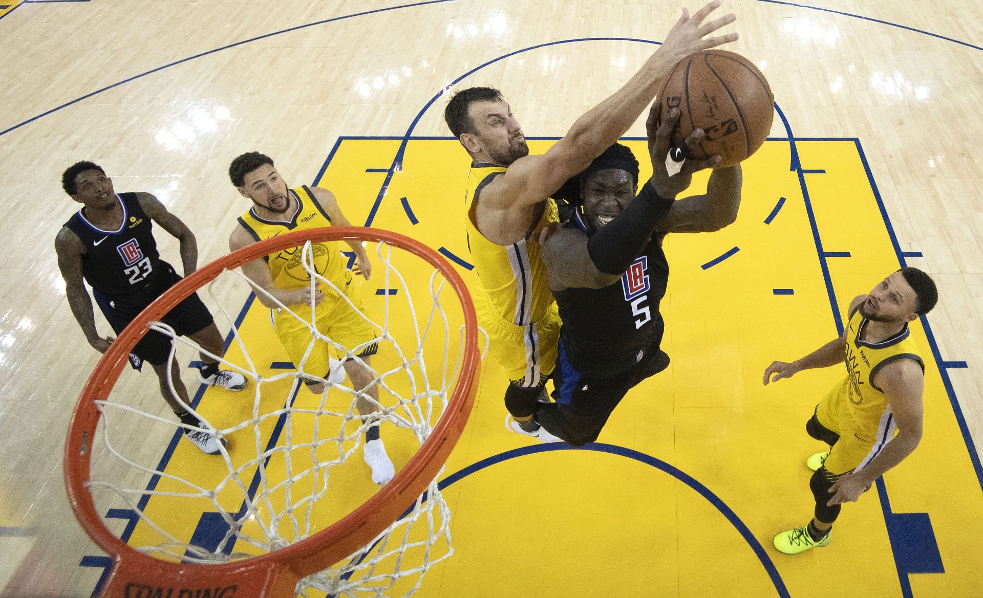epa07509326 LA Clippers forward Montrezl Harrell (2-R) goes to the basket as Golden State Warriors center Andrew Bogut (C) defends during NBA basketball Western Conference Playoffs game two between the Los Angeles Clippers and the Golden State Warriors at the Oracle Arena in Oakland, California, USA, 15 April 2019.  EPA/KYLE TERADA / USA TODAY SPORTS / POOL SHUTTERSTOCK OUT