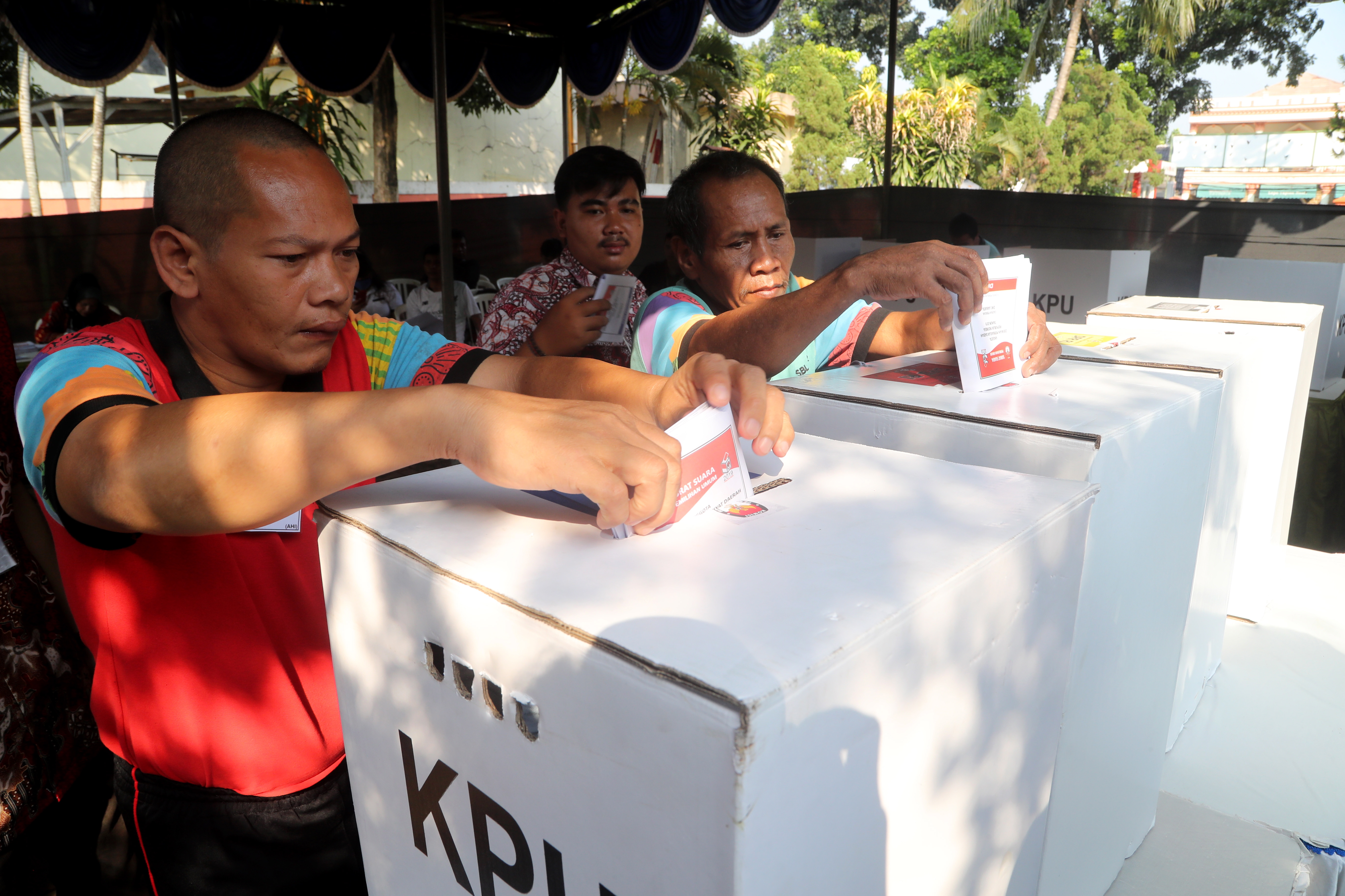 epa07511177 Two Indonesian mentally disabled men vote during the general election at a polling station in Jakarta, Indonesia, 17 April 2019. More than 192 million Indonesians cast their votes to elect the president, vice president and members of the House of Representatives as well as Regional Representative Council.  EPA/BAGUS INDAHONO