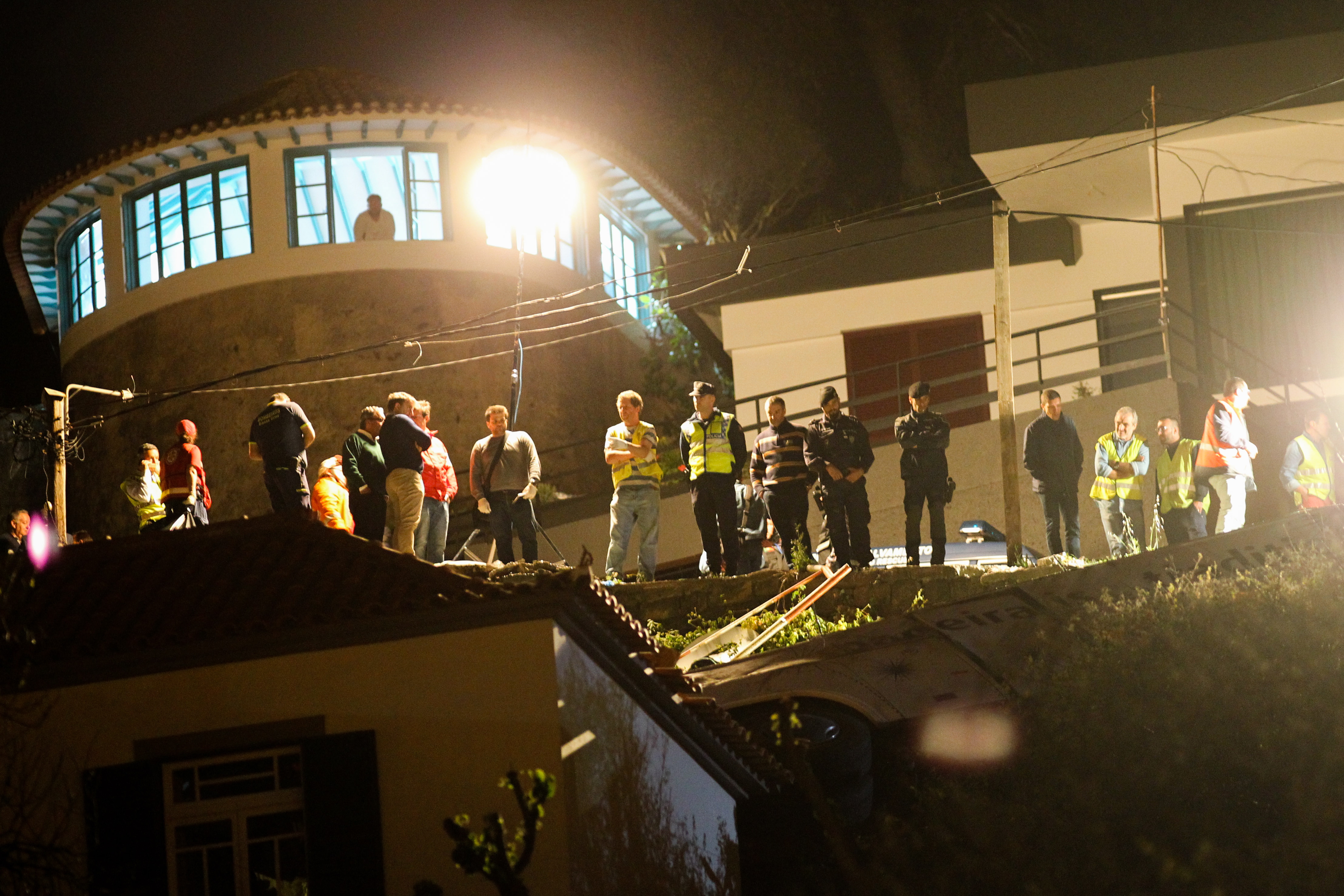 epa07512963 Emergency personnel at the site where an accident involving a tourist bus has caused deaths in Caniço, Santa Cruz, Madeira Island, Portugal, 17 April 2019. According the Civil Protection of Madeira, the accident occurred at 18:30 and 19 emergency medical vehicles are on site. According to media repots at least 28 people were killed in the crash.  EPA/HOMEM GOUVEIA