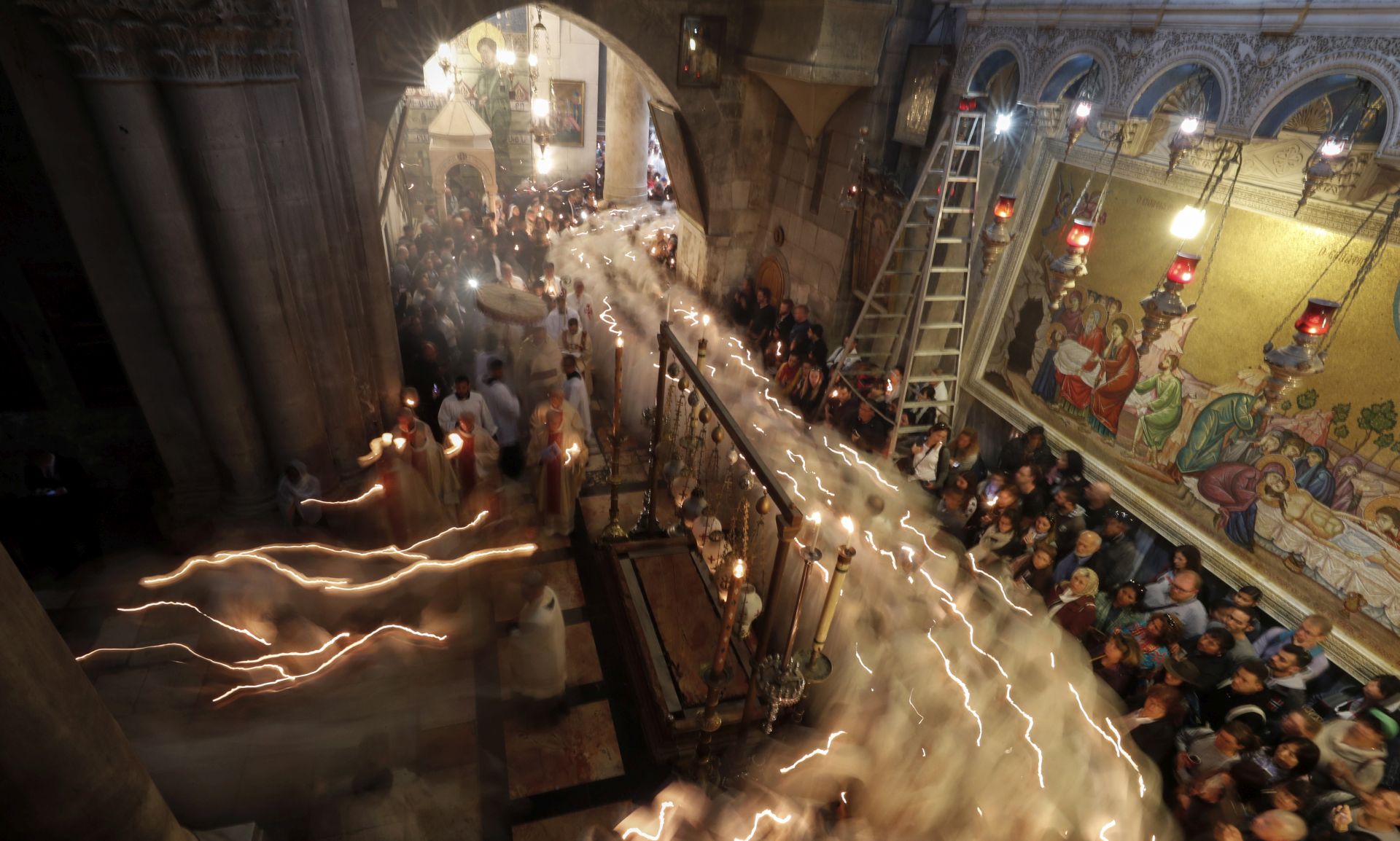 epa07513514 A picture taken with a slow shutter speed effect shows Christian worshippers take part in the procession of the holy Thursday, during the Catholic Washing of the Feet ceremony on Easter Holy Week, at the Church of the Holy Sepulcher in Jerusalem's old city, 18 April 2019.  EPA/ATEF SAFADI