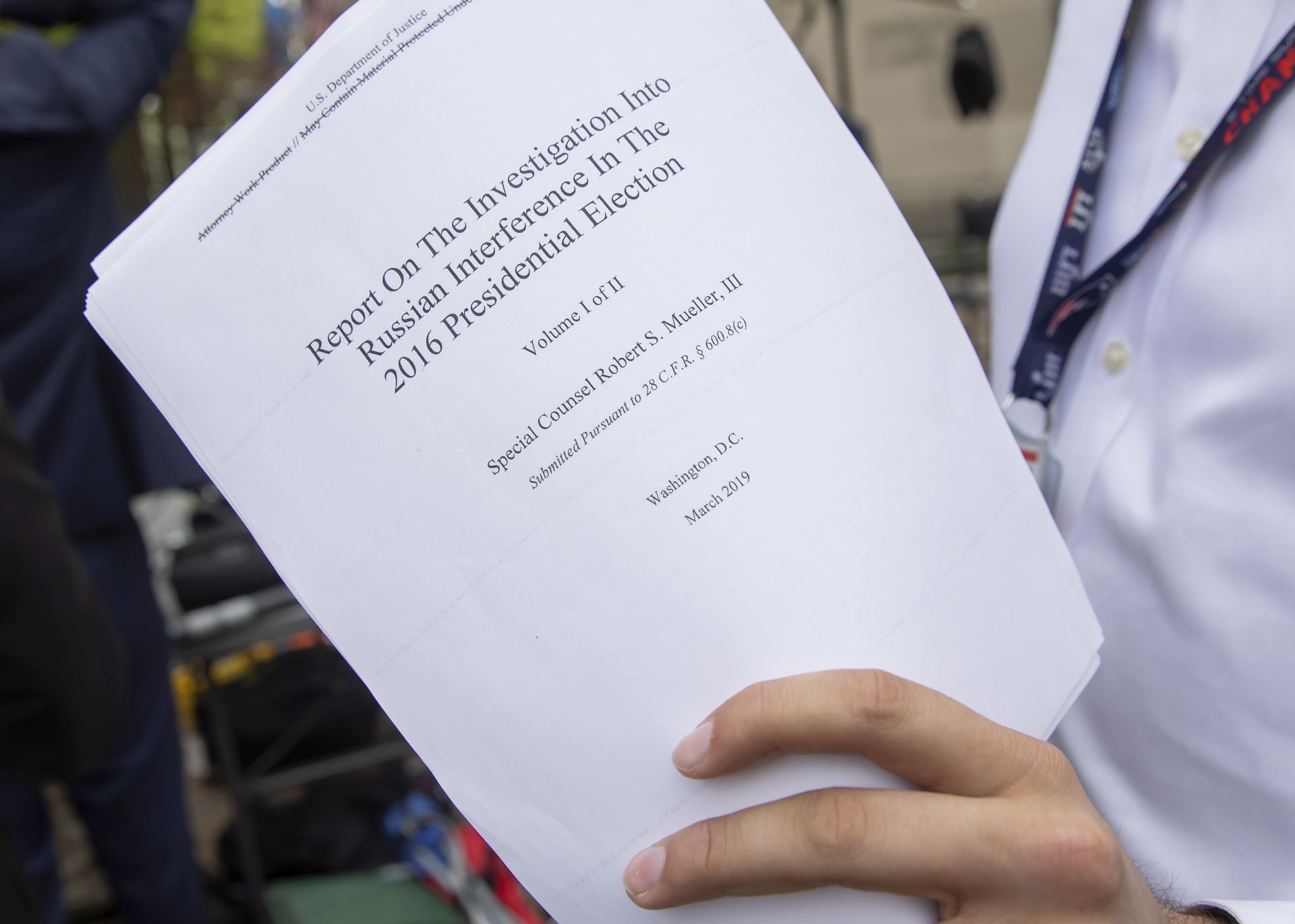 epa07514220 A reporter holds a printout of the redacted version of Special Counsel Robert Mueller's report on Russian interference in the 2016 election minutes after its release outside the US Department of Justice in Washington, DC, USA, 18 April 2019. According to news reports, Mueller and his team could not conclude that US President Donald J. Trump obstructed justice during the investigation.  EPA/ERIK S. LESSER