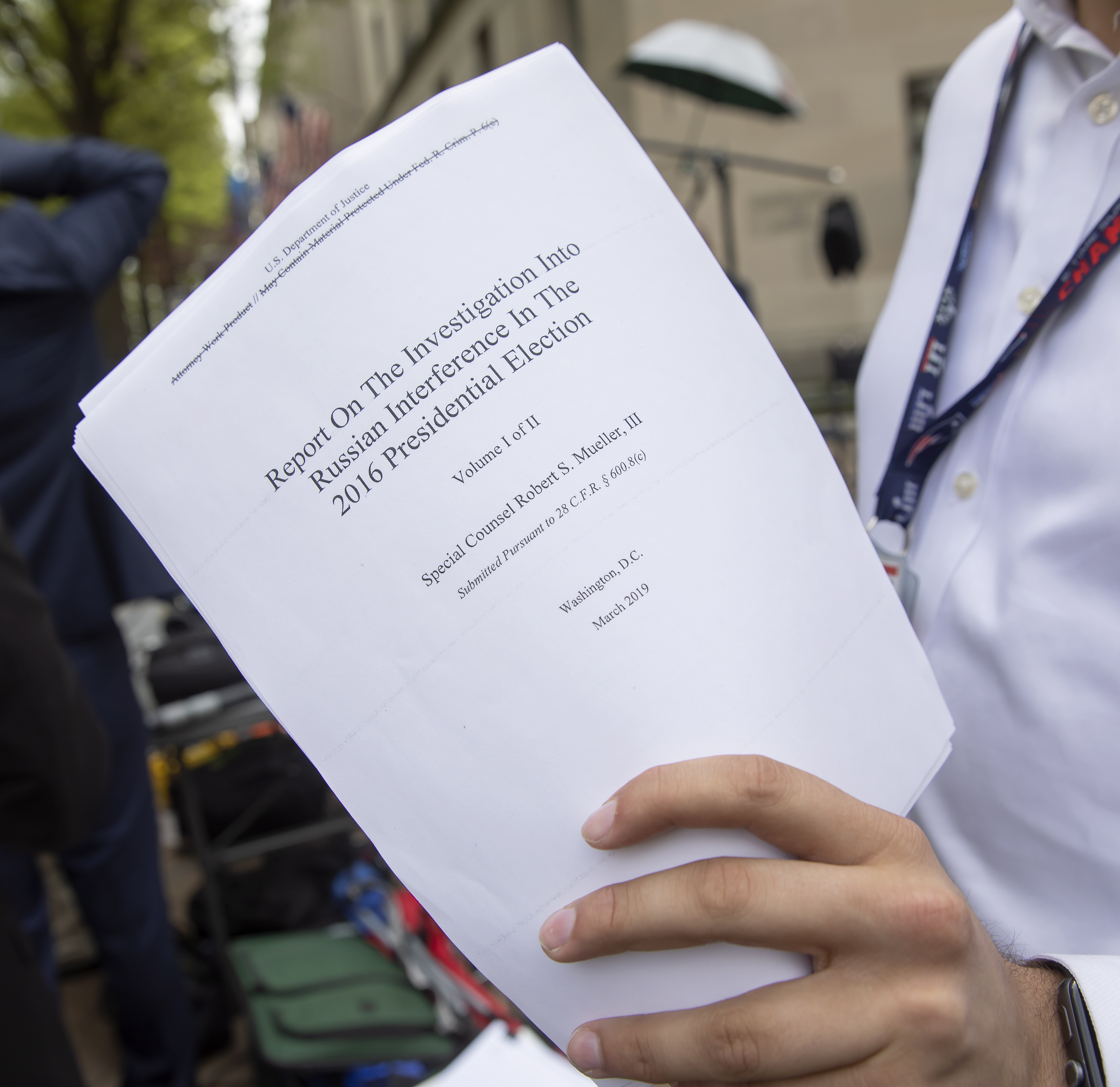 epa07514220 A reporter holds a printout of the redacted version of Special Counsel Robert Mueller's report on Russian interference in the 2016 election minutes after its release outside the US Department of Justice in Washington, DC, USA, 18 April 2019. According to news reports, Mueller and his team could not conclude that US President Donald J. Trump obstructed justice during the investigation.  EPA/ERIK S. LESSER