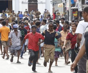 epa07521264 Sri Lankan people run for safety as authorities announced an evacuation of the area after a van was found parked with a suspected explosive device near  St Anthony's Church  Kochchikade in Colombo, Sri Lanka, 22 April 2019.  According to news reports, at least 290 people have been killed and over 500 were injured on 21 April 2019 in a series of blasts during Easter Sunday service at churches and hotels across Colombo.   EPA/M.A. PUSHPA KUMARA
