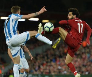 epa07530956 Liverpool's Mohamed Salah (R) vies for the ball against Huddersfield Erik Durm (L) during the English Premier League match between Liverpool FC and Huddersfield  at Anfield, Liverpool, Britain, 26 April 2019.  EPA/PETER POWELL EDITORIAL USE ONLY. No use with unauthorized audio, video, data, fixture lists, club/league logos or 'live' services. Online in-match use limited to 120 images, no video emulation. No use in betting, games or single club/league/player publications