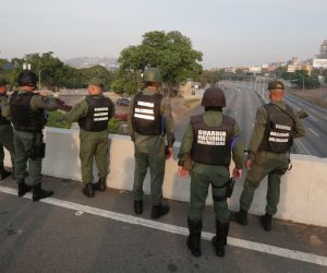 epa07537825 Venezuelan National Guard members on duty at La Carlota base, in eastern Caracas, Venezuela, 30 April 2019, where Venezuelan opposition Leopoldo Lopez (unseen) was led to meet with interim President Juan Guaido after being released from his home following his house arrest. Venezuelan interim President Juan Guaido has asked supporters to take to the streets in order to end the regime of President Nicolas Maduro. Meanwhile, Venezuelan opposition leader Leopoldo Lopez was freed from his house arrest, appearing alongside Guaido and military forces in Caracas.  EPA/RAYNER PENA
