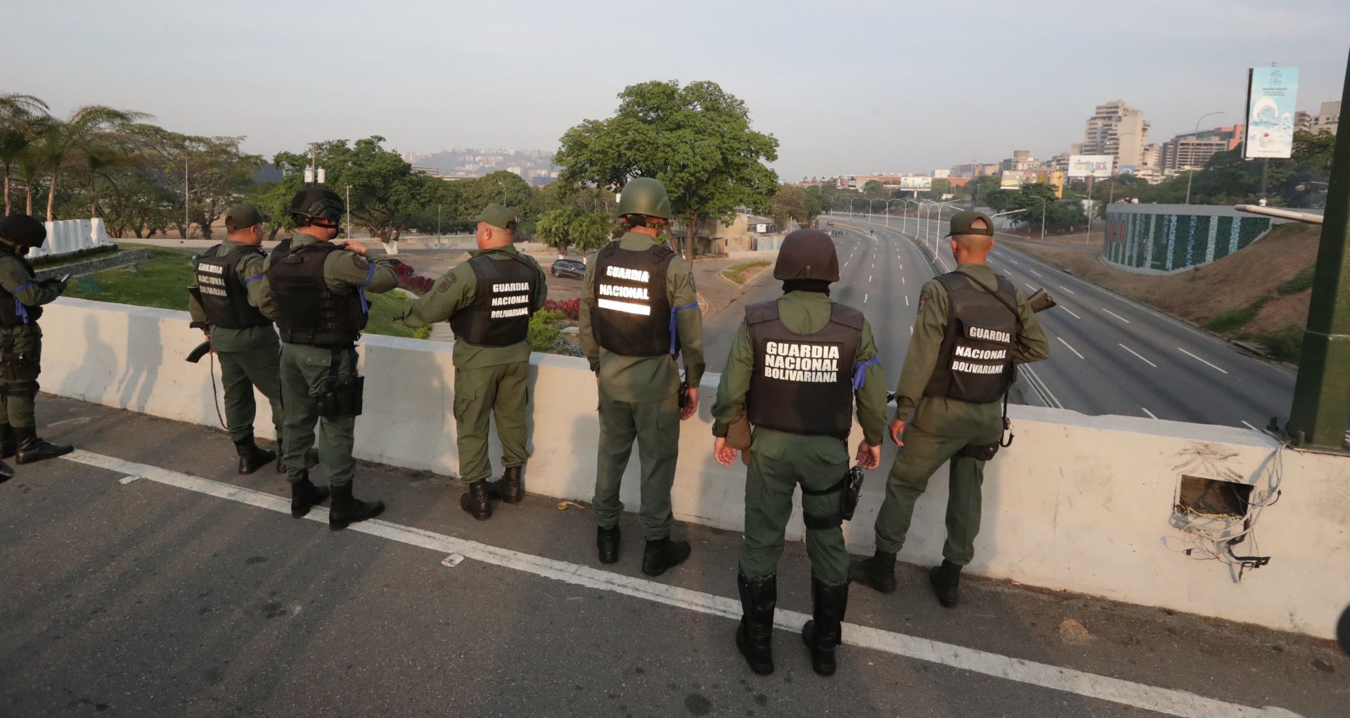 epa07537825 Venezuelan National Guard members on duty at La Carlota base, in eastern Caracas, Venezuela, 30 April 2019, where Venezuelan opposition Leopoldo Lopez (unseen) was led to meet with interim President Juan Guaido after being released from his home following his house arrest. Venezuelan interim President Juan Guaido has asked supporters to take to the streets in order to end the regime of President Nicolas Maduro. Meanwhile, Venezuelan opposition leader Leopoldo Lopez was freed from his house arrest, appearing alongside Guaido and military forces in Caracas.  EPA/RAYNER PENA