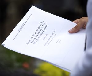 epa07514219 A reporter holds a printout of the redacted version of Special Counsel Robert Mueller's report on Russian interference in the 2016 election minutes after its release outside the US Department of Justice in Washington, DC, USA, 18 April 2019. According to news reports, Mueller and his team could not conclude that US President Donald J. Trump obstructed justice during the investigation.  EPA/ERIK S. LESSER