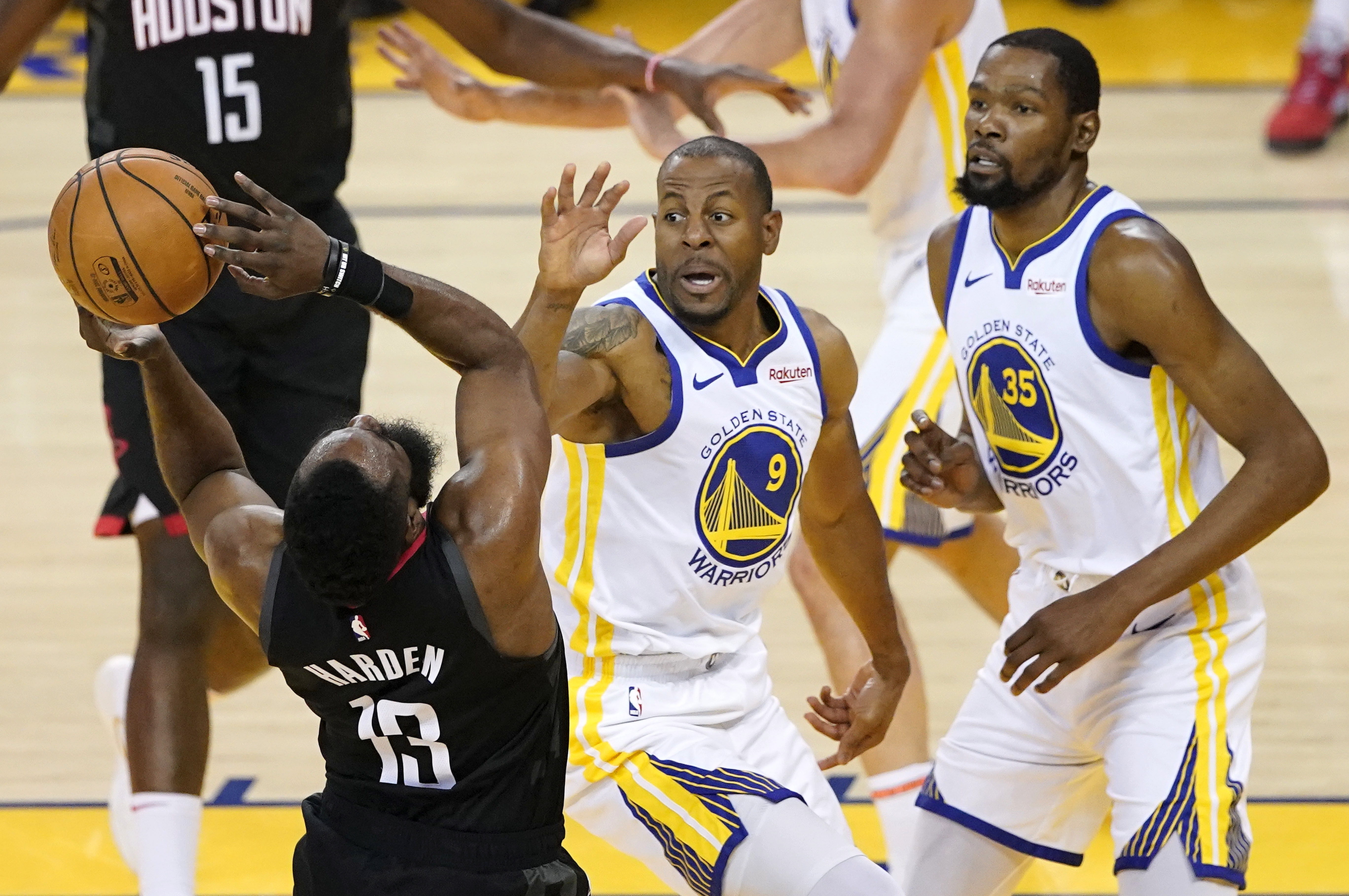 epa07535330 Houston Rockets guard James Harden (L) shoots while drawing a foul by Golden State Warriors guard Andre Iguodala (C) as Golden State Warriors forward Kevin Durant (R) looks on during the first half of the NBA Western Conference playoffs semifinals at Oracle Arena in Oakland, California, USA, 28 April 2019.  EPA/JOHN G. MABANGLO SHUTTERSTOCK OUT