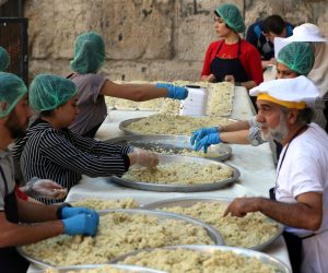 epa07554278 Syrian members of a charitable foundation prepare food for fasting people in the old city of Damascus, Syria, 07 May 2019. The event is organized to offer food for the poor during the holy month of Ramadan. Muslims around the world celebrate the holy month of Ramadan by praying during the night time and abstaining from eating, drinking, and sexual acts during the period between sunrise and sunset. Ramadan is the ninth month in the Islamic calendar and it is believed that the revelation of the first verse in Koran was during its last 10 nights.  EPA/YOUSSEF BADAWI