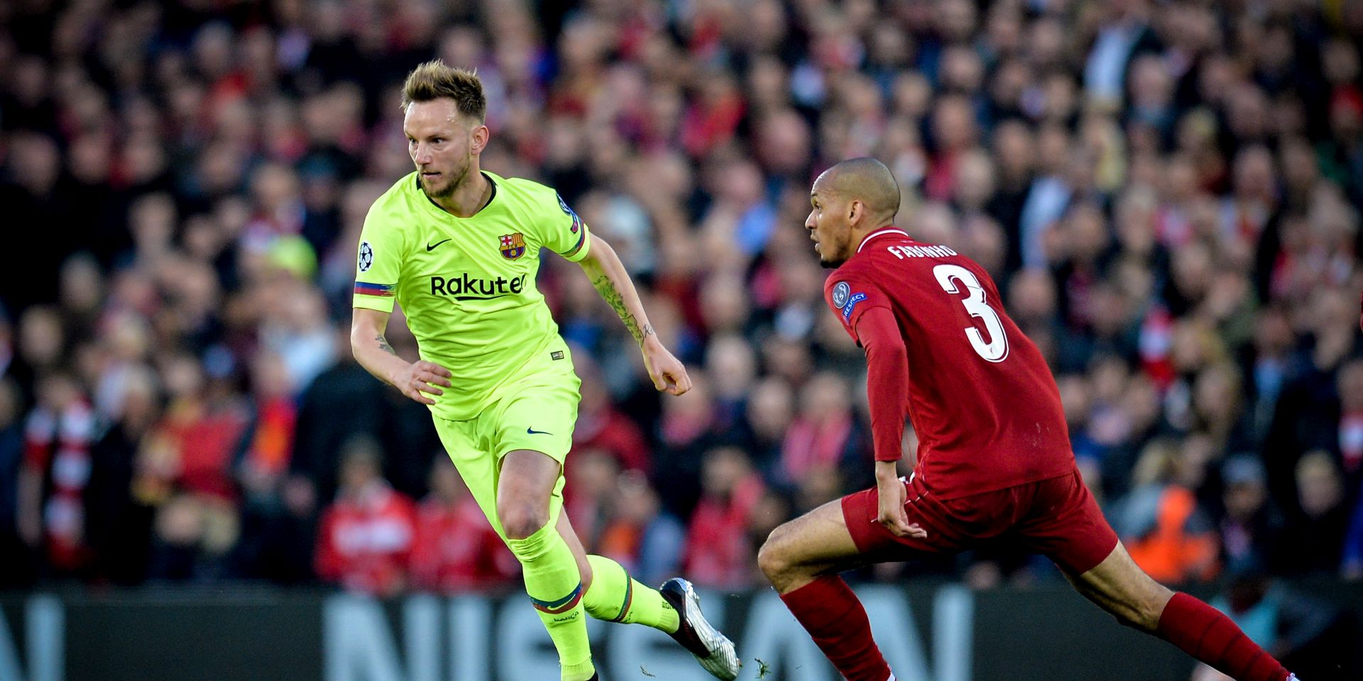 epa07554501 Barcelona's Ivan Rakitic (L) in action against Liverpool's Fabinho (R) during the UEFA Champions League semi final second leg soccer match between Liverpool FC and FC Barcelona at Anfield stadium in Liverpool, Britain, 07 May 2019.  EPA/PETER POWELL
