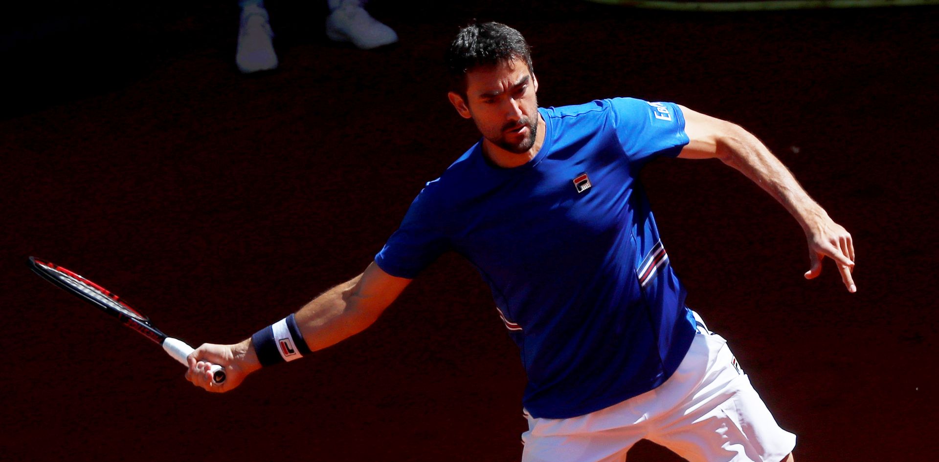 epa07557707 Marin Cilic of Croatia in action against Laslo Djere of Serbia during their third round match of the Mutua Madrid Open tennis tournament at the Caja Magica complex in Madrid, Spain, 09 May 2019.  EPA/CHEMA MOYA