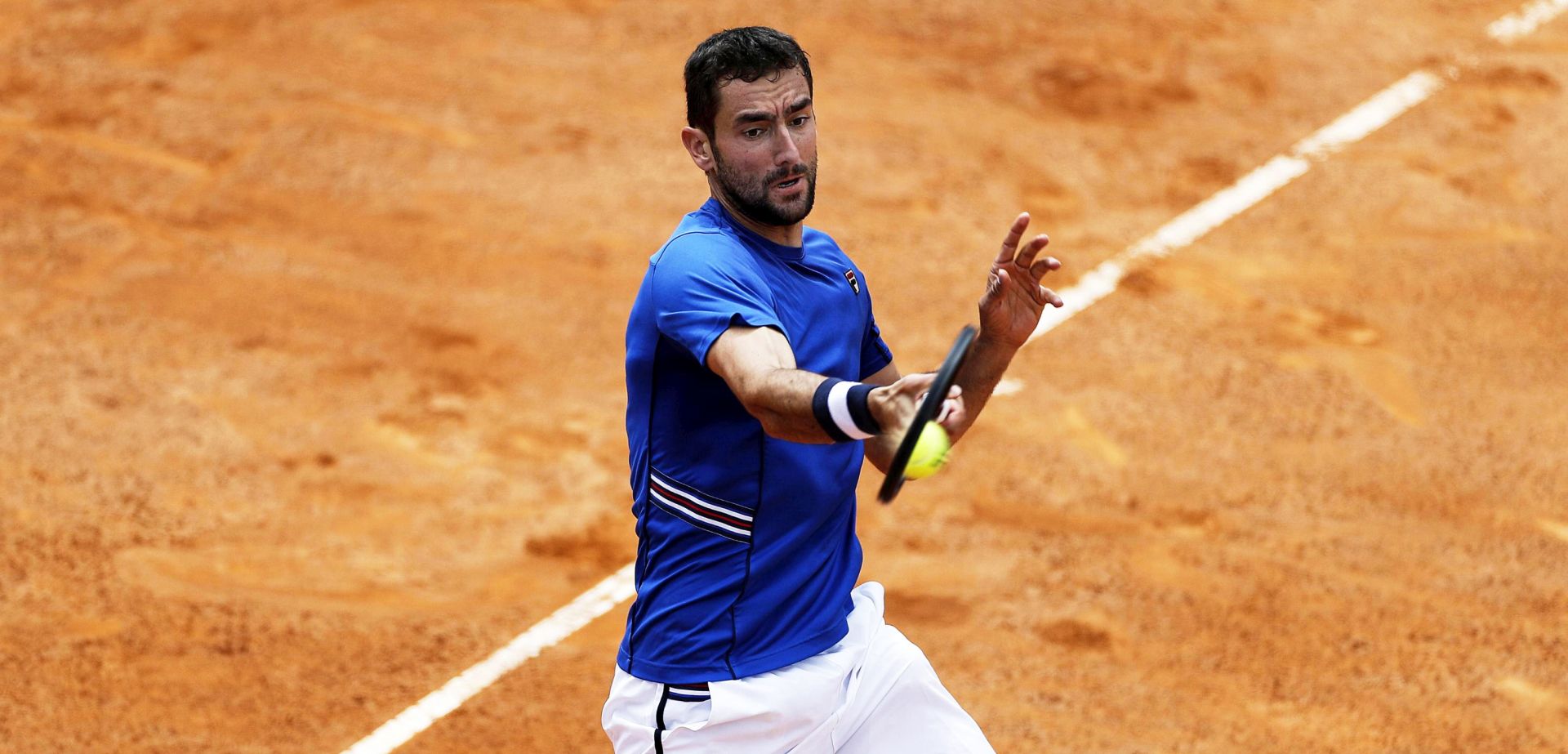 epa07569887 Marin Cilic of Croatia in action against Andrea Basso of Italy during their men's singles first round match at the Italian Open tennis tournament in Rome, Italy, 14 May 2019.  EPA/RICCARDO ANTIMIANI