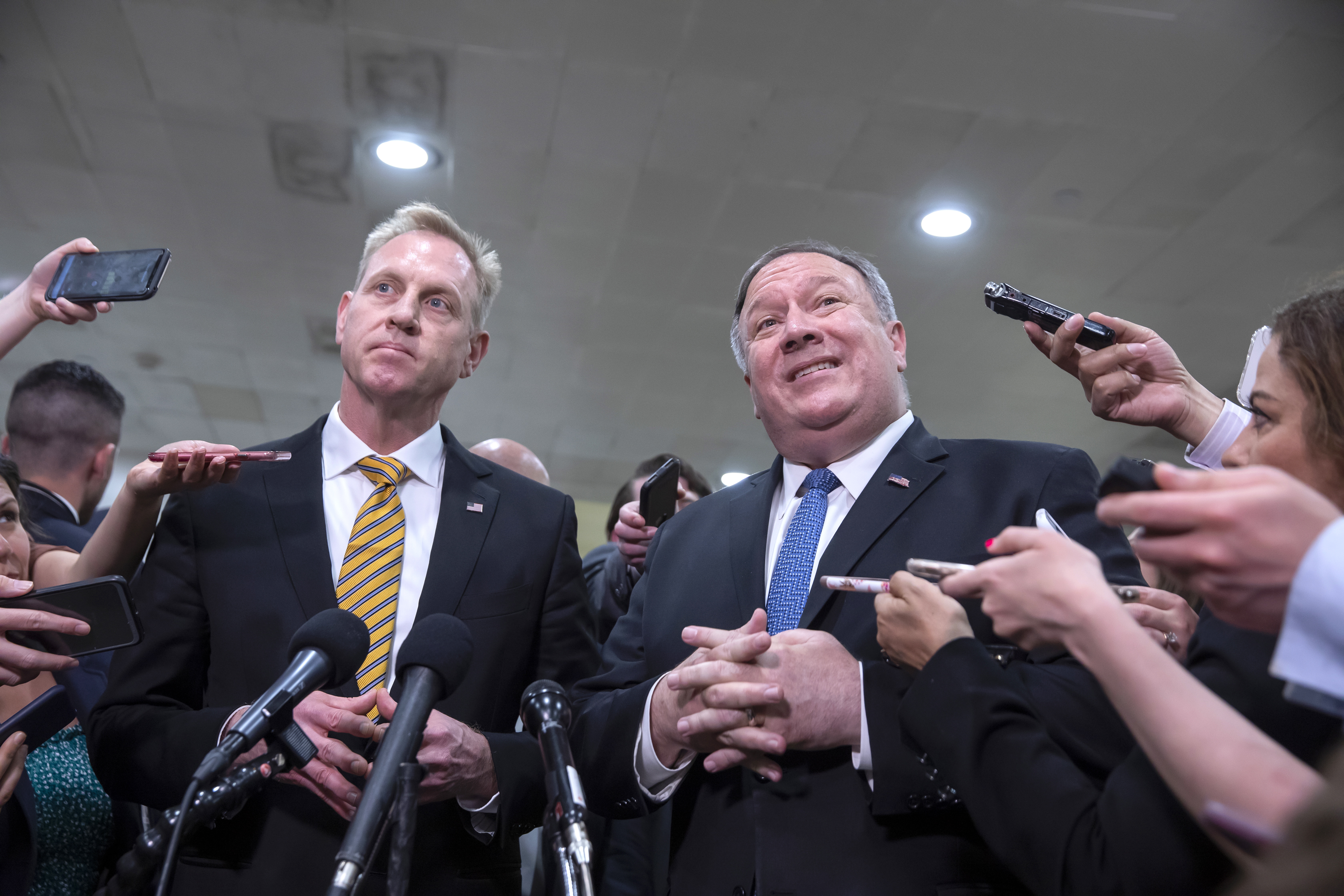 epa07590385 US Secretary of State Mike Pompeo (R) and Acting Defense Secretary Patrick Shanahan (L) speak to the new media after giving a classified intelligence briefings on Iran to members Congress at the Capitol in Washington, DC, USA, 21 May 2019. The administration of President Trump briefed Congress on intelligence that has prompted the US military build up against reported Iranian threats in the Persian Gulf region.  EPA/ERIK S. LESSER