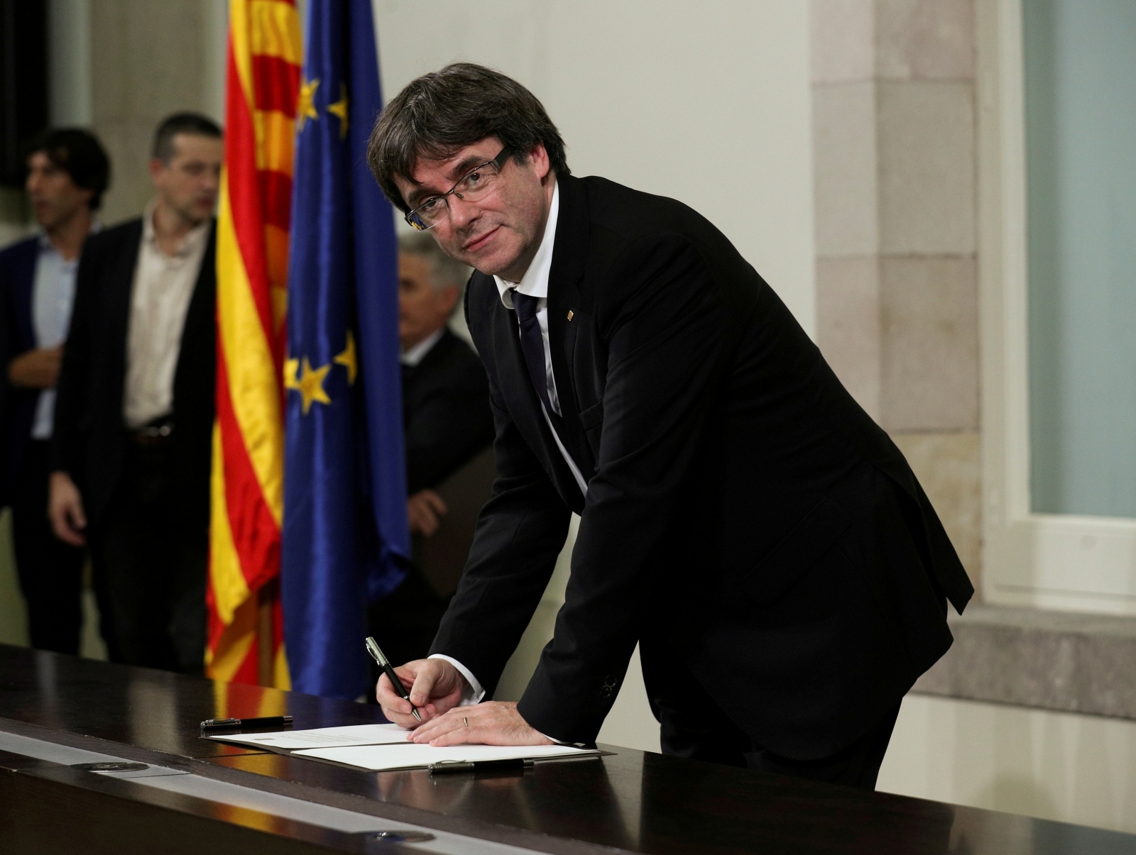 FILE PHOTO: Catalan President Carles Puigdemont signs a declaration of independence Catalan regional parliament in Barcelona FILE PHOTO: Catalan President Carles Puigdemont signs a declaration of independence at the Catalan regional parliament in Barcelona, Spain, October 10, 2017. REUTERS/Albert Gea/File Photo Albert Gea
