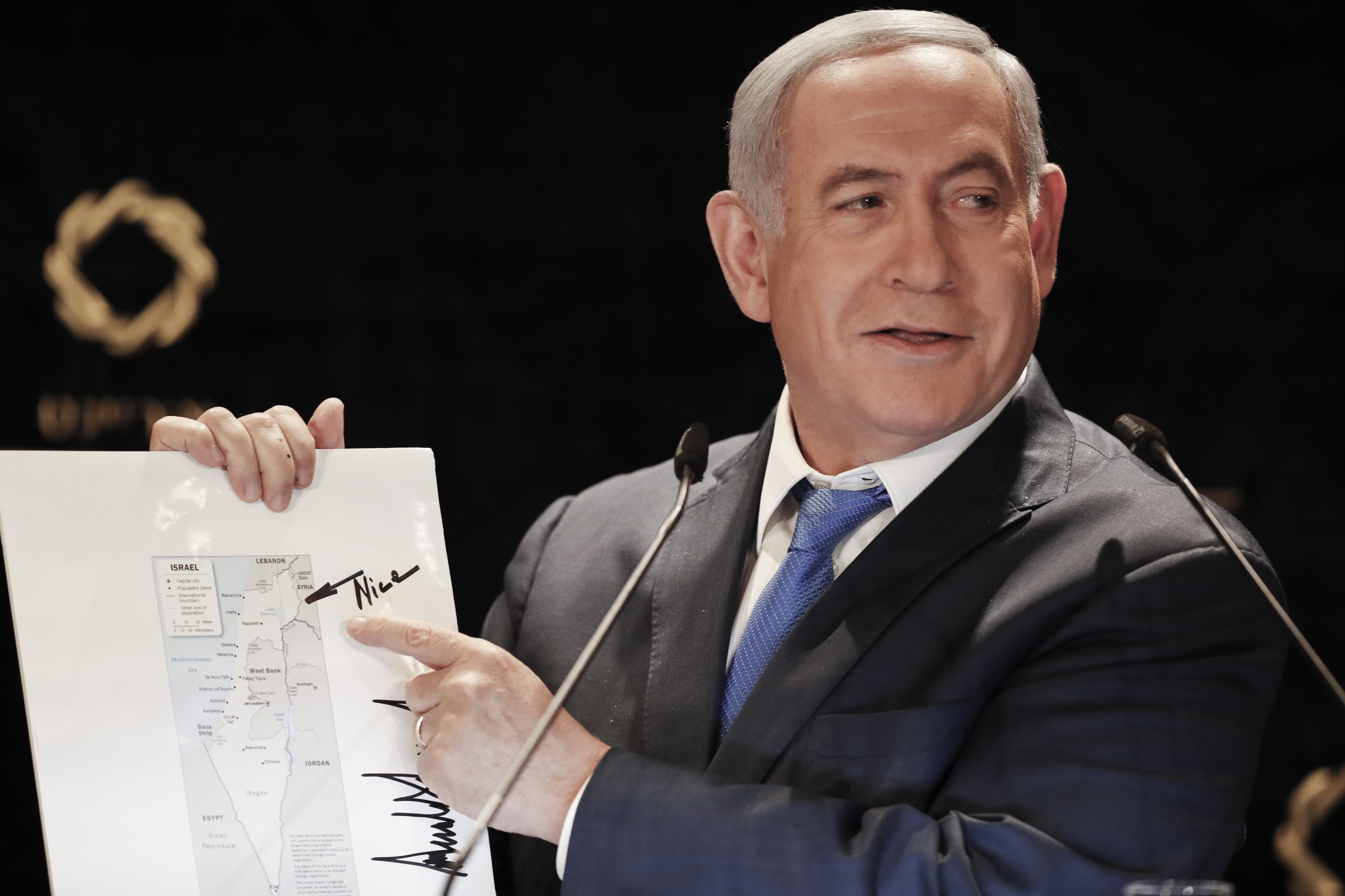 epa07613282 Israeli Prime Minister Benjamin Netanyahu points to the Golan Heights on a map of Israel featuring the signature of US President Donald J. Trump, while delivering a statement to members of the news media in Jerusalem, Israel, 30 May 2019. A visit by Senior Advisor to the White House Jared Kushner, comes one day after the Israeli parliament dissolved itself after Netanyahu failed to form a government coalition. The visit is also shortly ahead of Israeli-Palestinian peace plan talks scheduled in Manama.  EPA/ATEF SAFADI