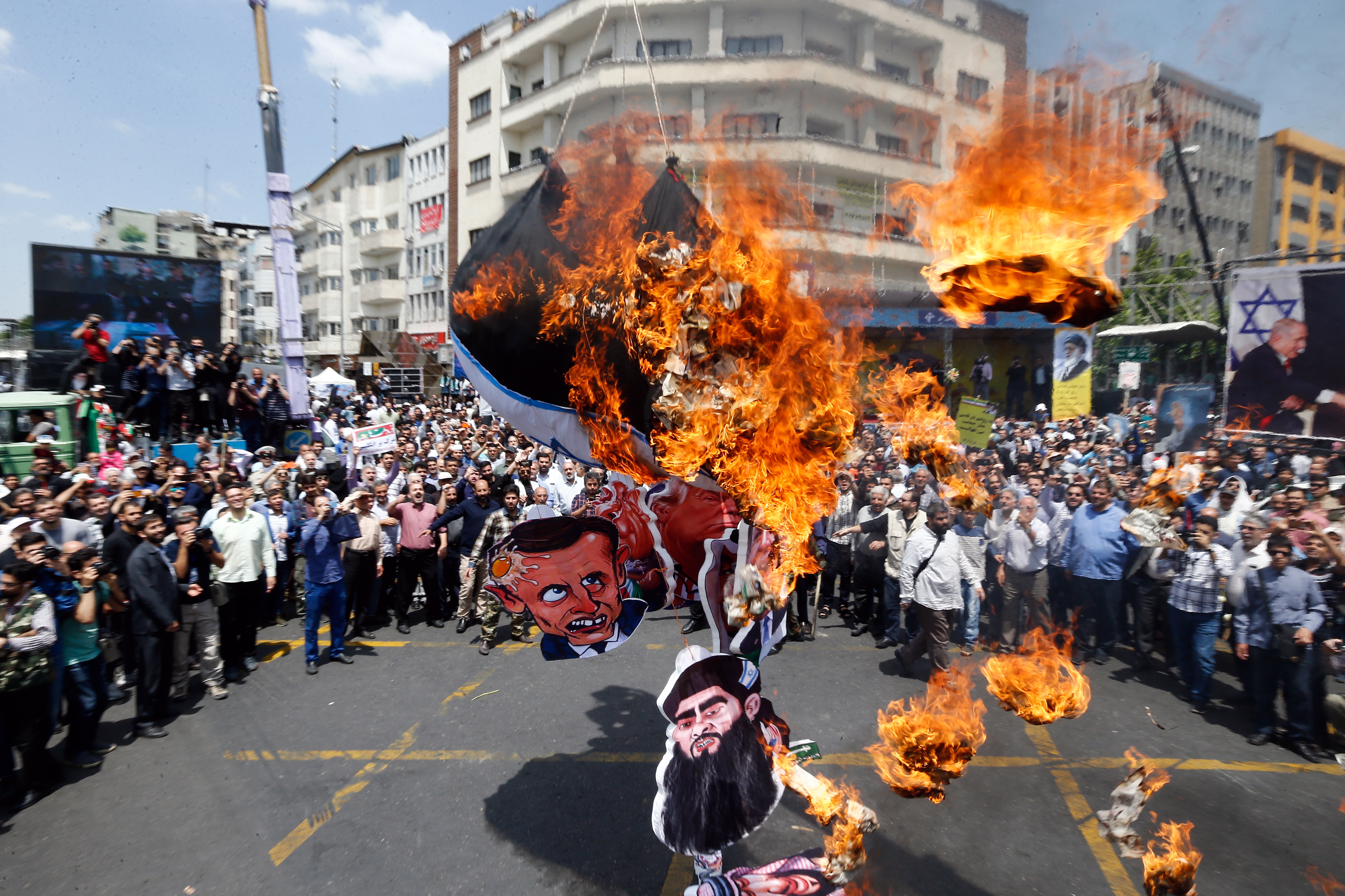 epa07614643 Iranians protesters burn the Israeli flag and an effigy depicting the face of King Salman of Saudi Arabia and others during an anti-Israel rally mark Al Quds Day (Jerusalem Day), in support of Palestinian resistance against on the Israeli occupation, in Tehran, Iran, 31 May 2019. Quds Day was started by the late Ayatollah Khomeini, founder of the Islamic Iranian republic, who called on the world's Muslims to show solidarity with Palestinians on the last Friday of the fasting month of Ramadan.  EPA/ABEDIN TAHERKENAREH