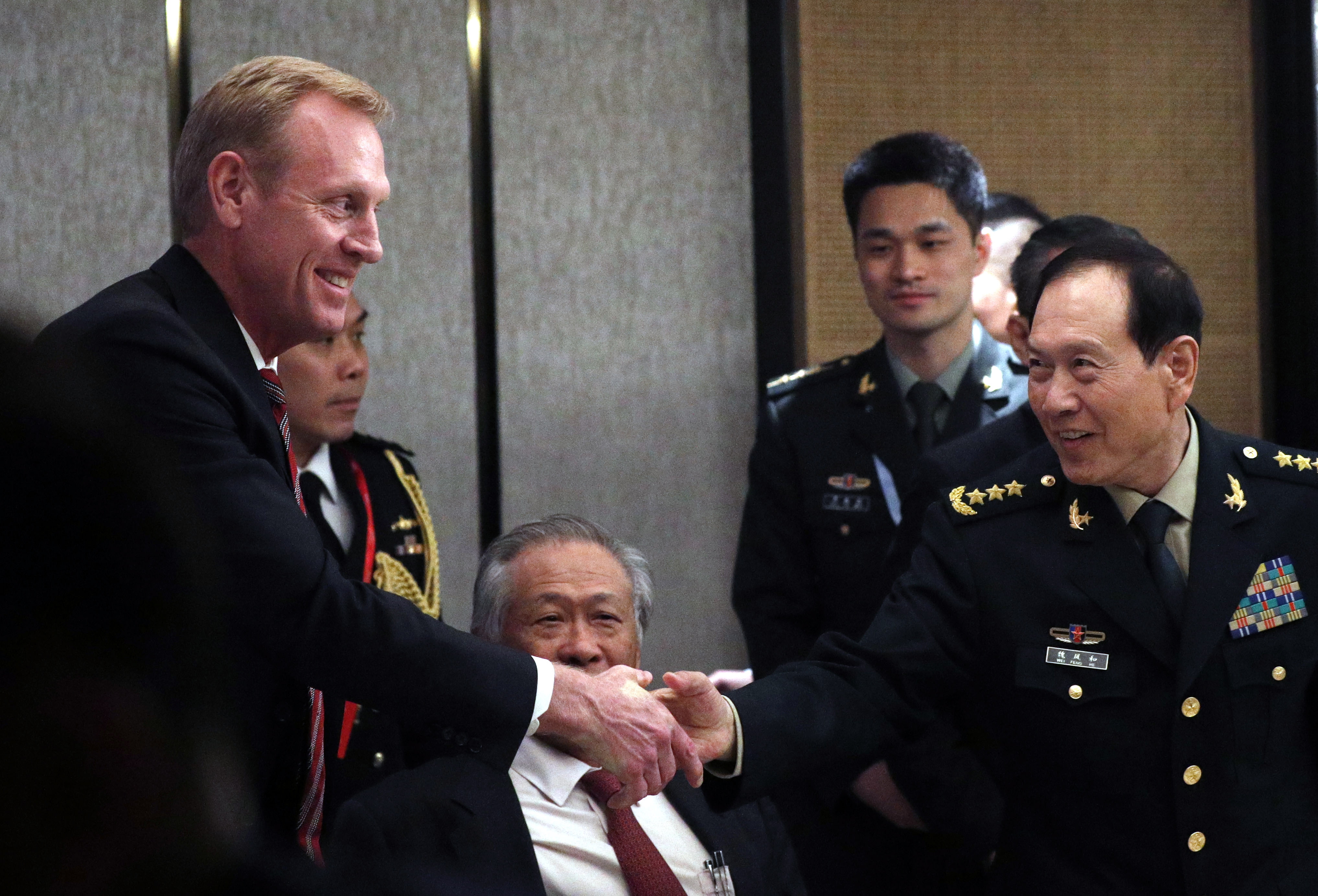 epa07616897 Acting US Secretary of Defense Patrick Shanahan (L) and Chinese Minister of Defense General Wei Fenghe (R) shakes hands during a ministerial roundtable on the sidelines of the International Institute for Strategic Studies (IISS) 18th Asia Security Summit in Singapore, 01 June 2019. The IISS Asia Security Summit is an annual gathering of defense officials in the Asia-Pacific region and is dubbed the Shangri-La Dialogue in honor of the hotel where the event is held. The summit will be held from 31 May to 02 June 2019.  EPA/WALLACE WOON
