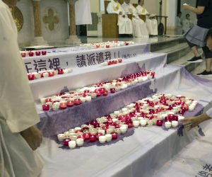 epa07616784 Worshippers put candles on a banner showing a map of China in from of the altar during a mass commemorating the 30th anniversary of the 1989 Beijing Tiananmen Massacre in Hong Kong, China, 31 May 2019, (issued 01 June 2019). The Justice and Peace Commission of the Hong Kong Catholic Diocese held a mass officiated by Cardinal Joseph Zen Ze-kiun. Zen, who outspoken on issues regarding human rights, political freedom, and religious liberty, has spearheaded opposition to the Vatican's rapprochement with Beijing.  EPA/JEROME FAVRE