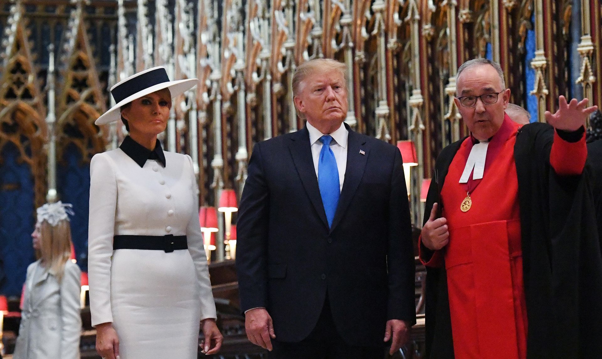 epa07622810 US President Donald J. Trump (C) with Dean of Westminster and a chaplain to the Queen Elizabeth II John Hall (R) and US First Lady Melania Trump (L) take a tour of Westminster Abbey in London, Britain, 03 June 2019. US President Trump and his wife are on a three-day official visit to the UK.  EPA/ANDY RAIN