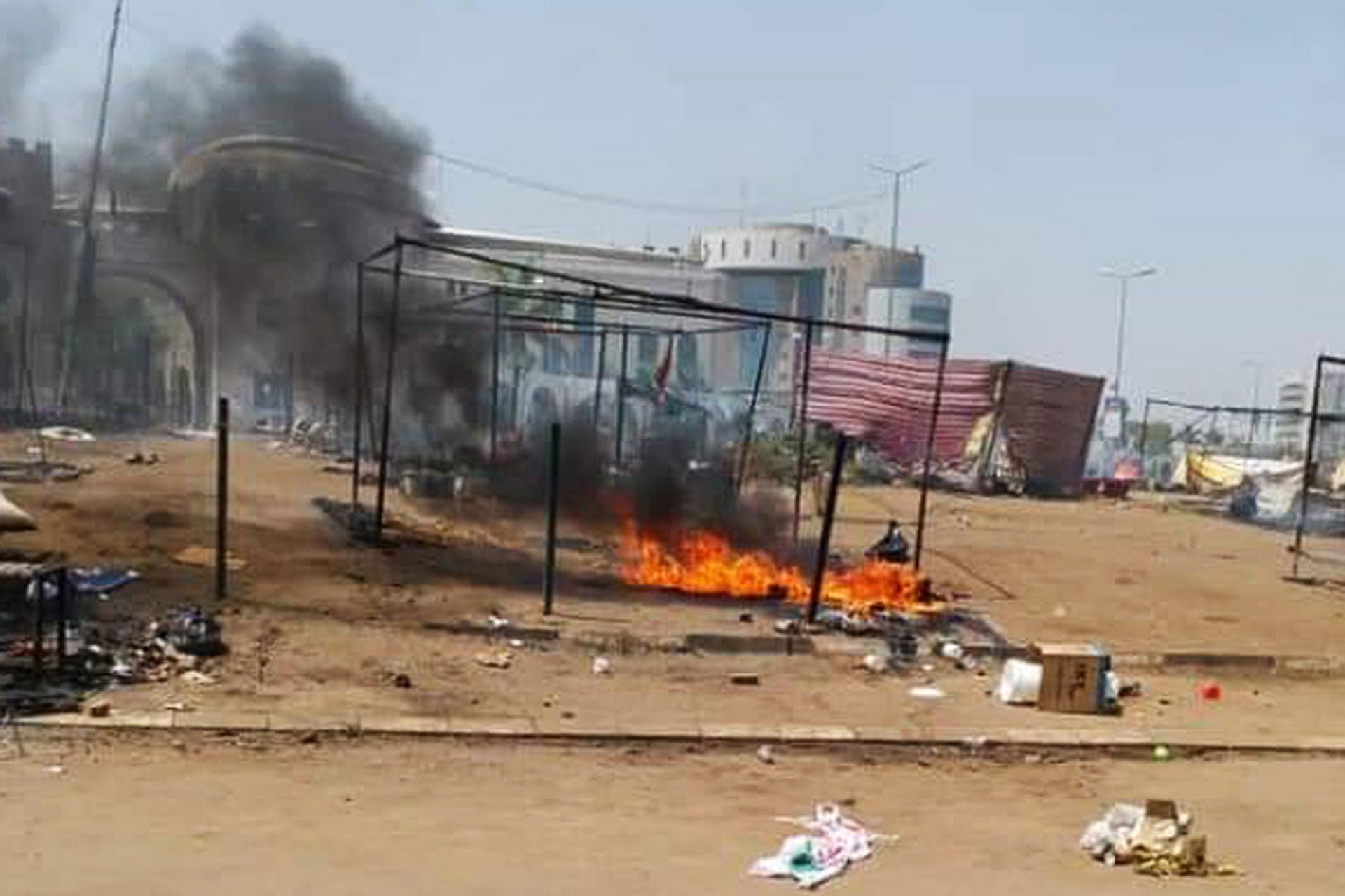 epa07622629 Smoke seen rising inside the sit-in site outside the Sudanese army headquarters, few hours  after news of an early morning clearing by security forces from various media reports, in Khartoum, Sudan, 03 June 2019. According to media reports 13 protesters were killed and several others injured in clashes between the Sudanese protesters and Sudan's military to break up a sit-in.  In retaliation the opposition called for national civil disobedience to put pressure on the Transitional Military Council (TMC) to hand power over to a civilian administration.  EPA/MARWAN ALI ALTERNATIVE CROP OF epa07622335