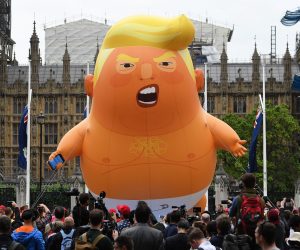 epa07624036 Anti Trump protesters with a Trump baby blimp flying over Parliament Square gather for a protest against US President Donald J. Trump State visit to the UK in London, Britain, 04 June 2019. US President Trump and First Lady Trump are on a three-day official visit to Britain.  EPA/ANDY RAIN