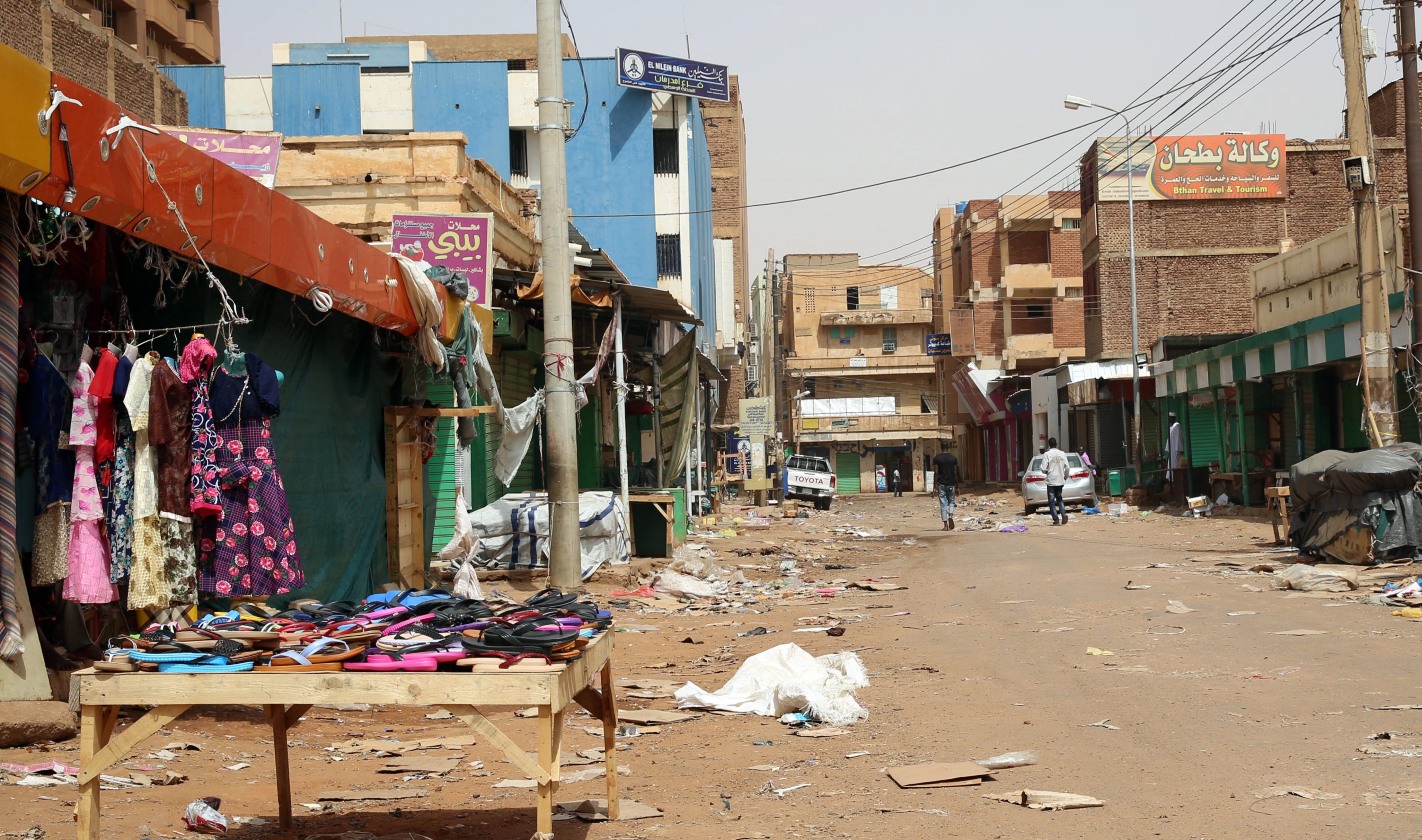epa07636519 People walk down an empty street closed in the Omdurman market, near Khartoum, Sudan, 08 June 2019. Sudanese protest group called on demonstrators participating in the first day of the 'Civil Disobedience' campaign, which was called in the wake of a deadly attack on protesters.The Sudanese Professionals Association (SPA) said the campaign would run until a civilian government was put in charge by the country's ruling generals.  EPA/MARWAN ALI