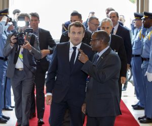 epa07640477 Deputy Director General of the International Labour Organisation (ILO) for Field Operation Moussa Oumarou (R) welcomes French President Emmanuel Macron (C) during the 108th session of the International Labour Conference - ILO Centenary Session, at the European headquarters of the United Nations in Geneva, Switzerland, 11 June 2019.  EPA/SALVATORE DI NOLFI