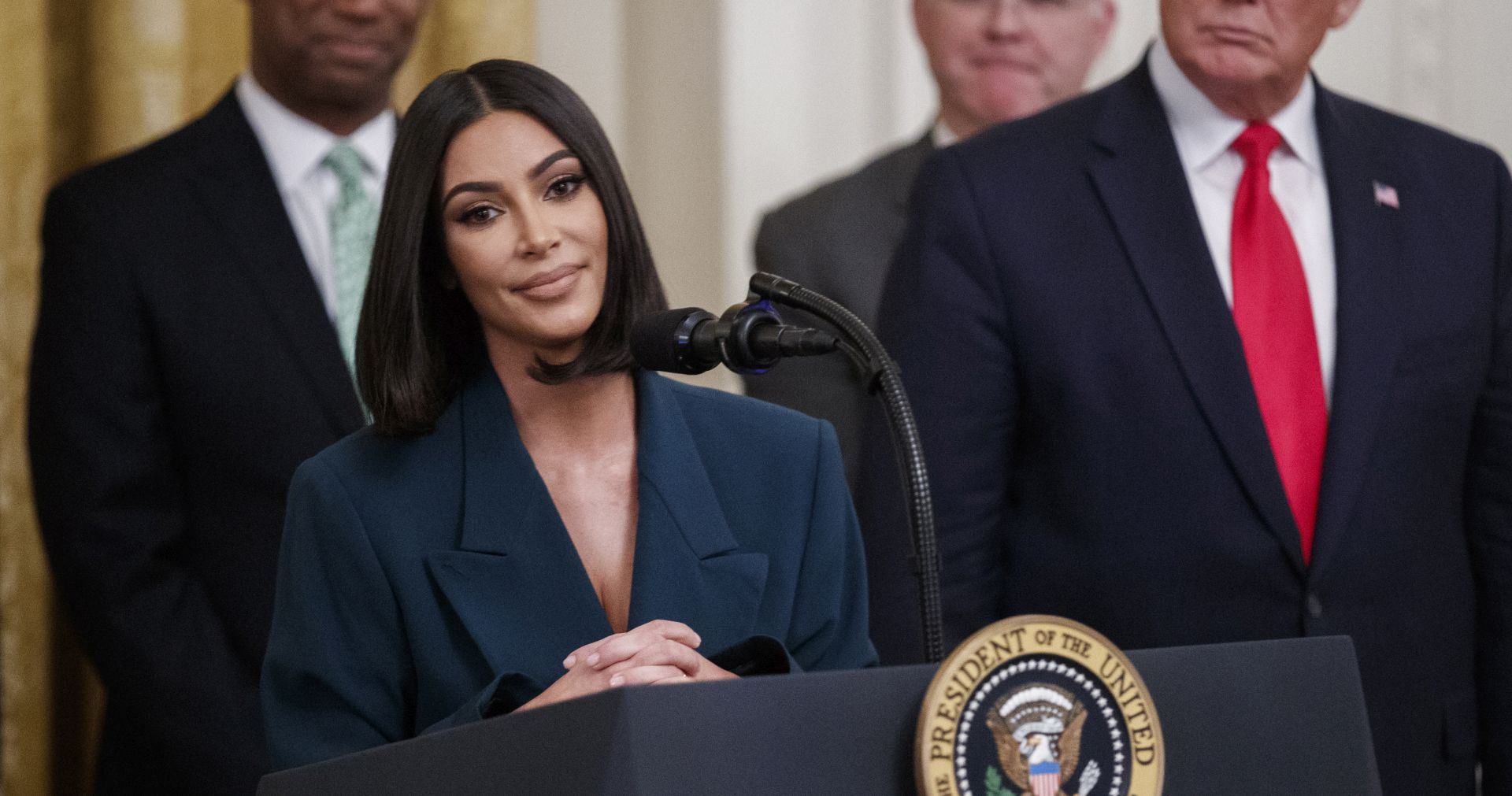 epa07646641 Reality star turned activist Kim Kardashian West (L) joined US President Donald J. Trump (R) on stage to deliver remarks during an event on second chance hiring programs for felons following incarceration in the East Room of the White House in Washington, DC, USA, 13 June 2019. The administration announced it is working with the private sector and non-profit organizations to help give former prisoners a second chance at the American dream.  EPA/SHAWN THEW