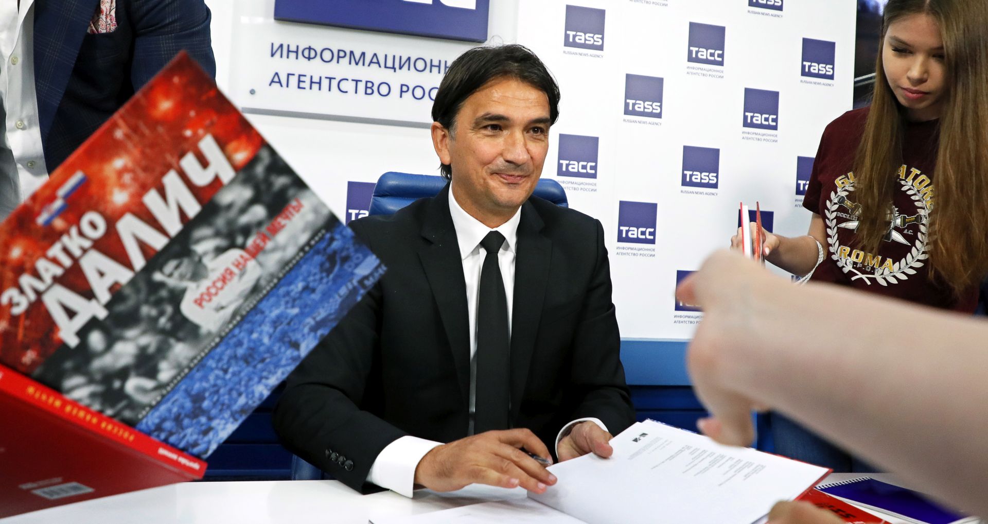 epa07647468 Croatian national soccer team head coach Zlatko Dalic signs books during the presentation of his book 'Russia of Our Dreams' on the FIFA World Cup 2018 in Moscow, Russia, 14 June 2019.  EPA/YURI KOCHETKOV