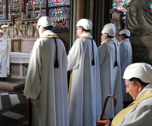 epa07650568 Clerics wear protective helmets as they attend a mass led by Michel Aupetit (L), Archbishop of Paris, which is the first church service in a side chapel of Notre-Dame de Paris cathedral in Paris, France, 15 June 2019, two months to the day after a devastating fire. For safety reasons, the mass was celebrated on a very small scale, but was streamed live on internet.  EPA/KARINE PERRET / POOL  MAXPPP OUT