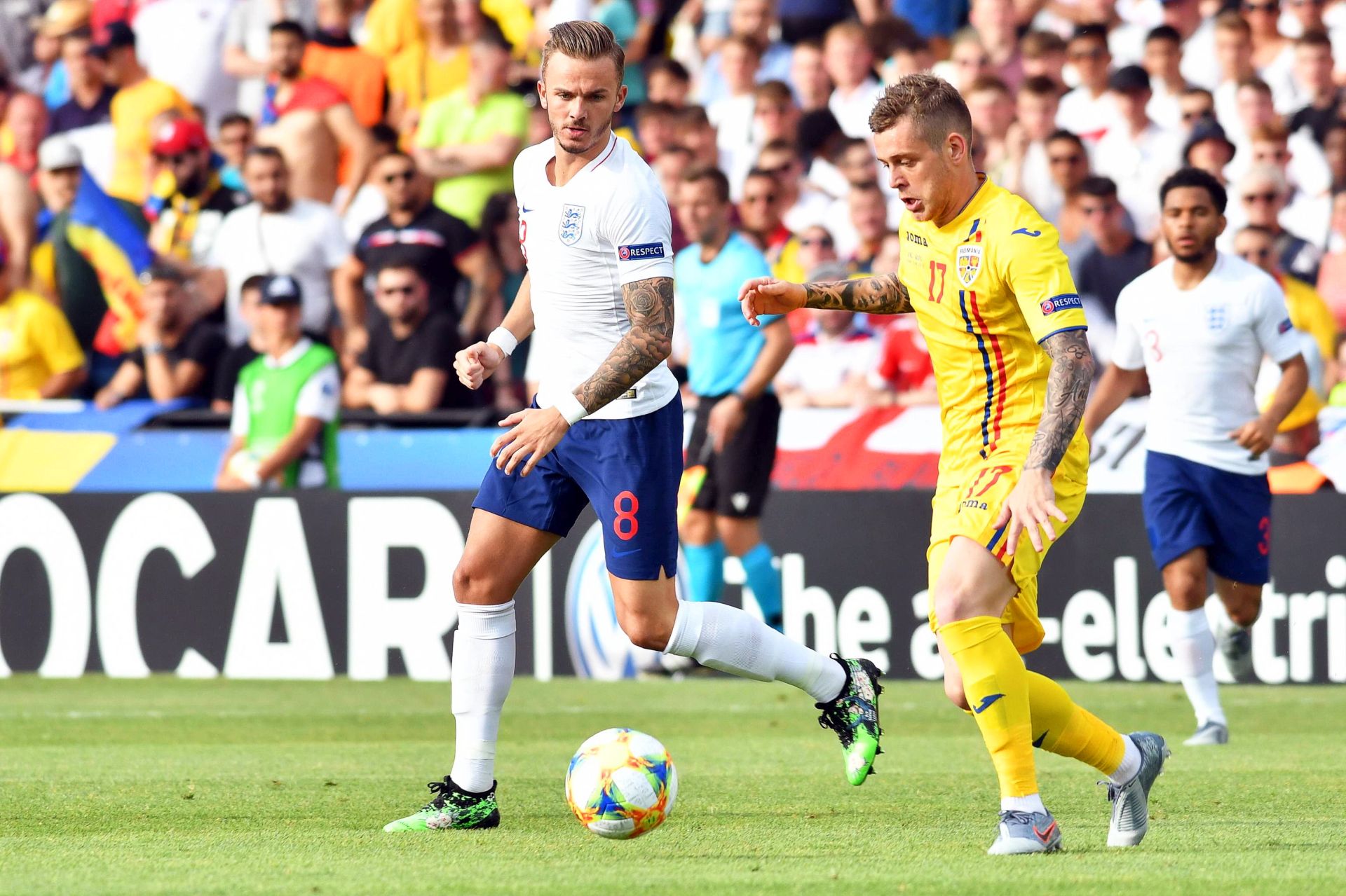 epa07664126 Alexandru Cicaldau (C) of Romania in action against James Maddison (L) of England during the UEFA European Under-21 Championship 2019 group C soccer match between England and Romania in Cesena, Italy, 21 June 2019.  EPA/ALESSIO TARPINI