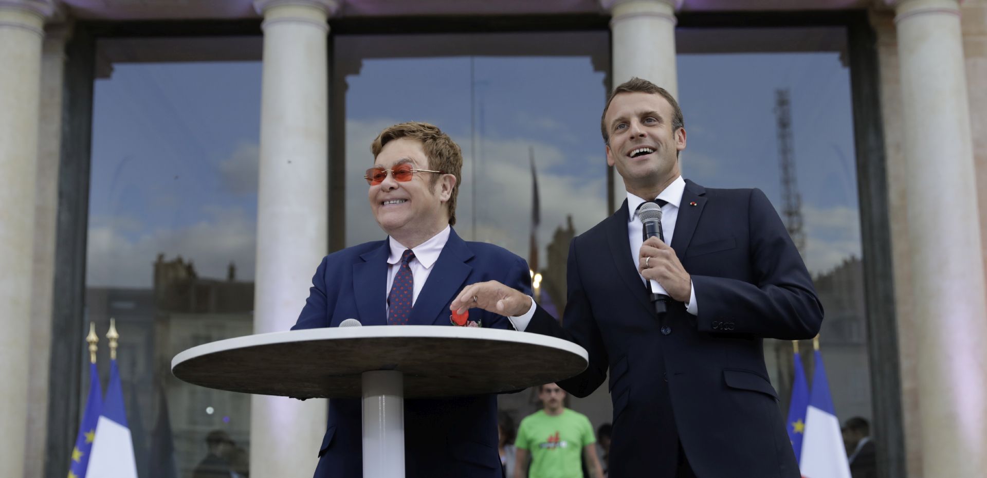epa07664290 French President Emmanuel Macron, right, and Sir Elton John speak in the courtyard of the presidential Elysee Palace in Paris, France, 21 June 2019. Sir Elton John received the Legion of Honor, France's highest award, during a visit to the presidential Elysee Palace  EPA/Lewis Joly / POOL MAXPPP OUT