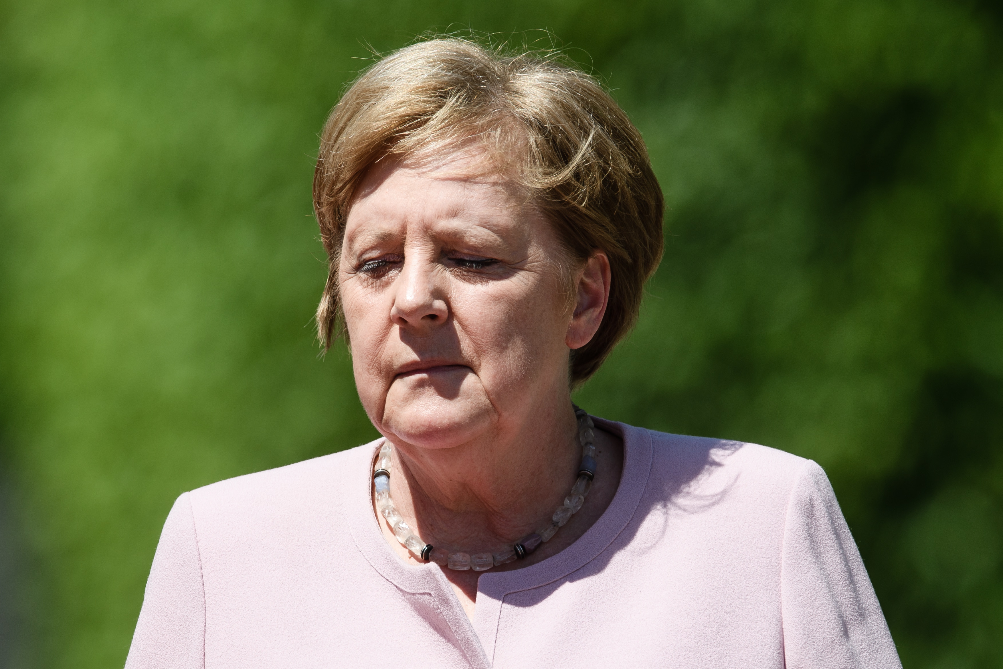 epa07677008 (FILE) - German Chancellor Angela Merkel during a reception with military honors for visiting Ukraine's President Zelensky at the Chancellery in Berlin, Germany, 18 June 2019 (reissued 27 June 2019). German Chancellor Merkel, during an official event for the handing over of certificates of appointment and discharge to Ministers of Justice at Bellevue Palace in Berlin on 27 June 2019, was seen trembling, once again, eight days after a similar incident that occurred on 18 June 2019, during Ukraine's President Zelensky's visit to the country, media reported. The first episode was attributed to heat and dehydration as she said had forgotten to drink enough water. Germany as well as other European countries is affected by a heat wave with temperatures soaring above 30 degrees Celsius.  EPA/CLEMENS BILAN