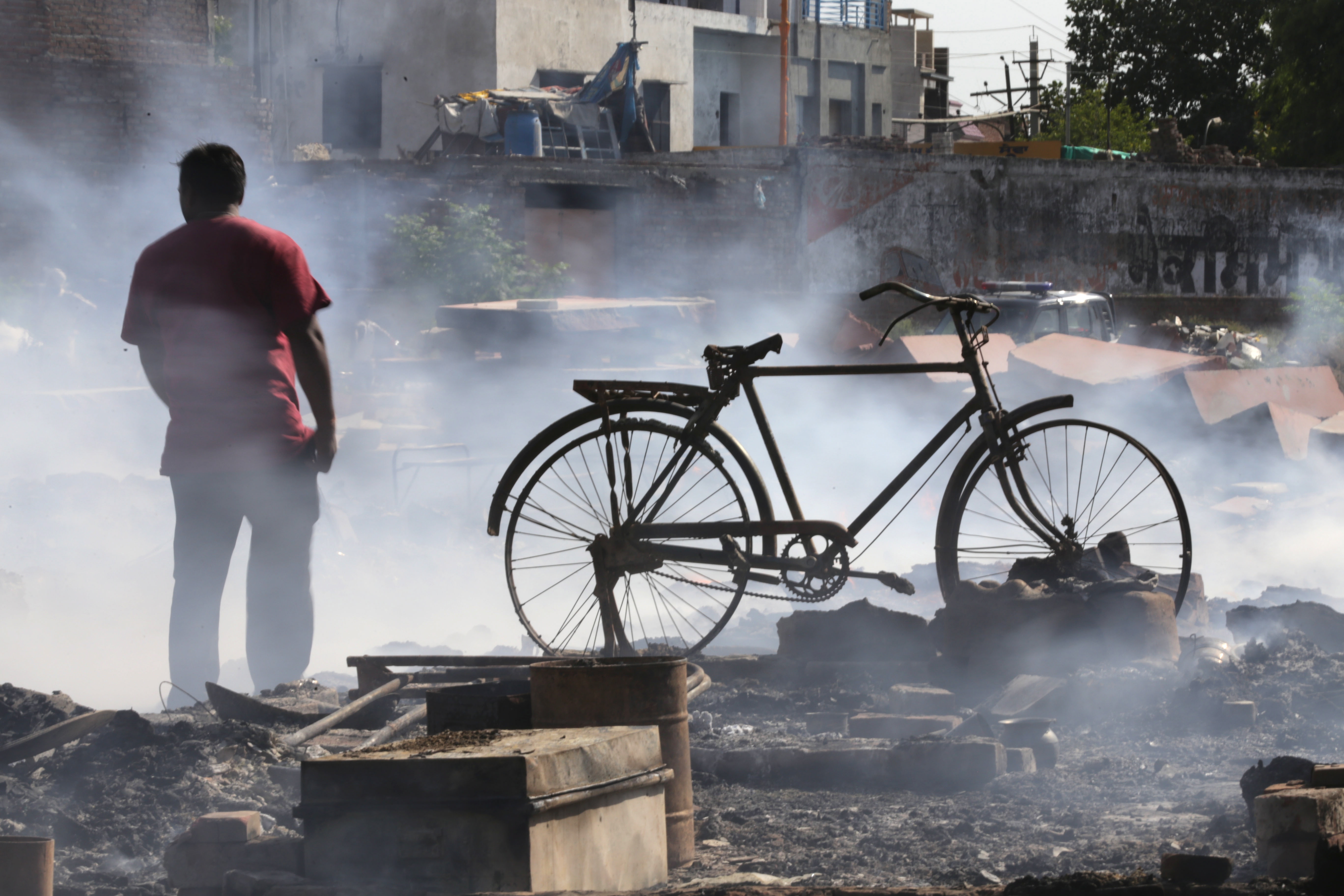 epa07677268 An Indian man searches for his belongings after a fire broke out in a slum area in Amritsar, India, 27 June 2019. According to reports, about 30-40 shanties were burnt in the fire, gutting most of the belongings of the residents. No casualties have been reported so far in the mishap.  EPA/RAMINDER PAL SINGH