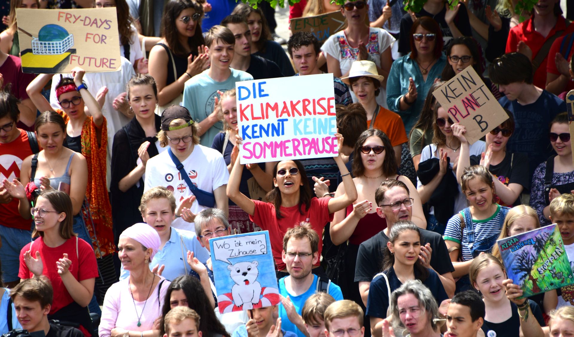epa07679656 An activist holds a cardboard reading 'the climate crisis knows no summer break', during a 'Fridays for Future' demonstration in Berlin, Germany, 28 June 2019. The growing 'Fridays for Future' movement, which started in the summer of 2018, demands compliance with the goals of the Paris Agreement and the 1.5 degree Celsius target.  EPA/CLEMENS BILAN