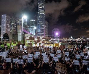 epa07681335 Protesters gather near a plot of land, which was just transferred to the People's Liberation Army (PLA), on the Victoria Harbour waterfront in Hong Kong, China, 29 June 2019. A group of anti-extradition bill protesters moved briefly onto a plot of land that automatically transferred to the PLA at midnight on Saturday. Police cleared the restricted site of protesters just minutes before the area was designated a dock of the PLA.  EPA/CHAN LONG HEI RESEND: LARGER FILE SIZE