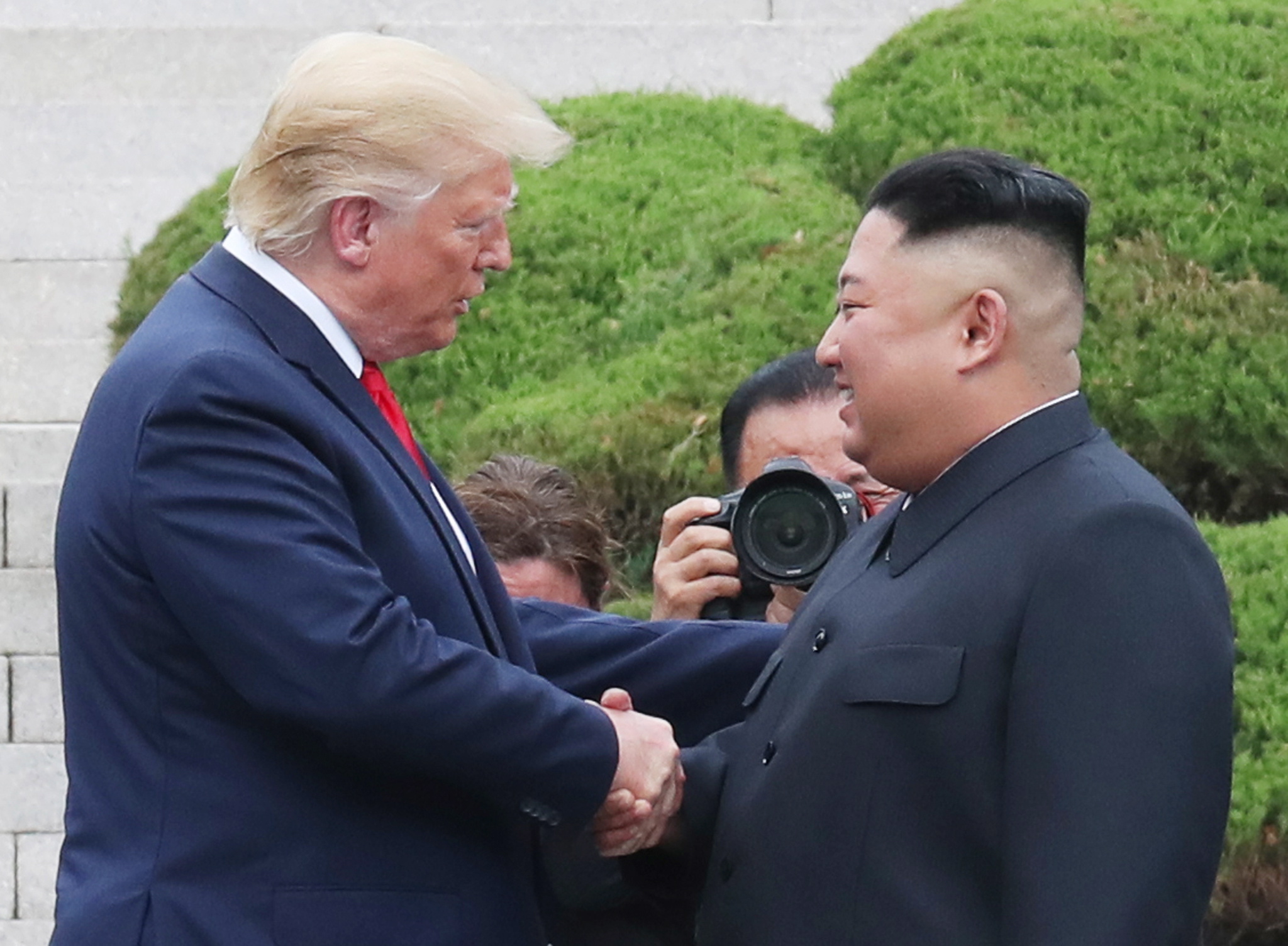 epa07683978 US President Donald J. Trump (L) with North Korean leader Kim Jong-un shake hands after crossing the Military Demarcation Line into the southern side of the truce village of Panmunjom in the Demilitarized Zone, which separates the two Koreas, 30 June 2019. The US leader arrived in South Korean on 29 June for a two-day visit that will include a meeting with South Korean President Moon Jae-in and a trip to the Demilitarized Zone.  EPA/YONHAP SOUTH KOREA OUT